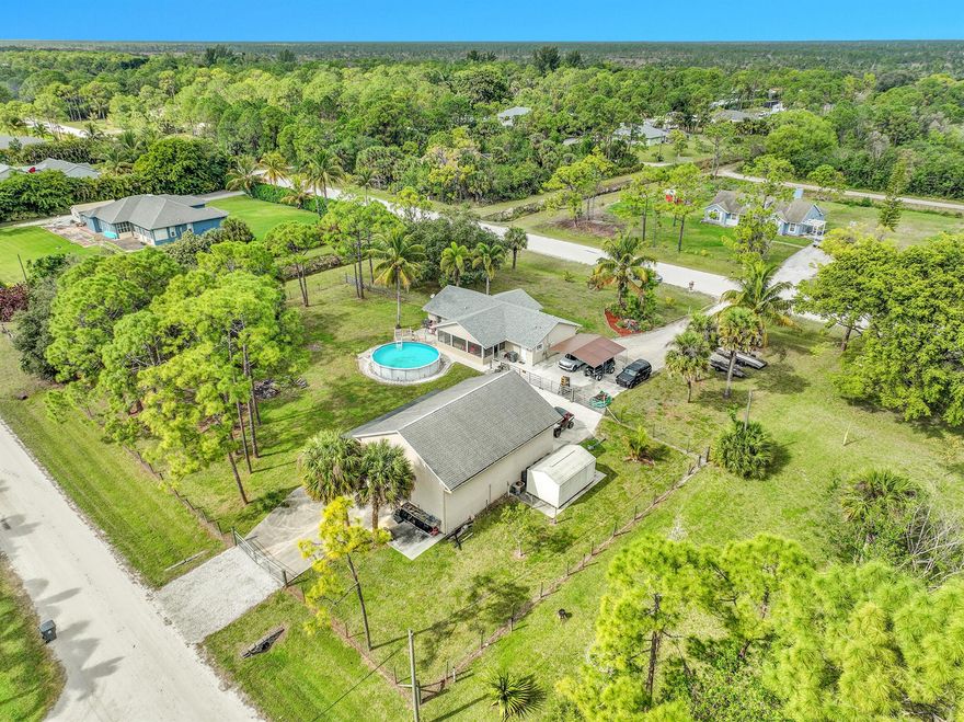 Luxury Acreage Living with an Enthusiast's Dream Workshop & Equestrian Potential!Discover the perfect blend of country charm and robust functionality at this exceptional CBS home on 1.5 fully fenced, meticulously manicured, street-to-street acres! CBS 3/2 HOME Perfect for Auto Enthusiasts! DETACHED 30X42 GARAGE/SHOP WITH A LIFT, AC, HEAT, WATER AND 220. 3 ROLL UP DOORS, UPSTAIRS ACCESS AND ALARM SYSTEM. PERFECT SET UP FOR RV. PADDOCK FOR THE HORSES. MAIN HOUSE HAS NEWER ROOF, SPLIT PLAN, GREAT ROOM. SEPARATE ALARM SYSTEM, SPRINKLER SYSTEM, FENCING HAS 3 SEPARATE GATES. Newer Washer and Dryer! AC Coils replaced in 2022! Above Ground pool! Primary Suite features a spa tub & Walk-in Shower!