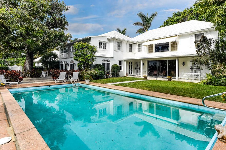 his exceptional, classic, property is located on the highly desirable Emerald Lane, which is very private and quiet-close to town, the beach and the Lake Trail. The downstairs has a formal entrance opening to a gracious large living room that leads to the separate dining room and 40 foot loggia. The doors to the loggia open to a very spacious patio with a mature tree and a pool on the side of the property. There is a paneled library with built in bookcases that leads to the updated gourmet kitchen with a center island and stainless appliances with an abundance of cabinets and storage. There is a large great room off of the kitchen overlooking the pool that has a cabana bathroom with two doors leading to a side yard. There are three bedrooms upstairs Ã¢â‚¬"each with en- suite bathrooms plus an expansive, spacious master, facing the pool, with a trey ceiling and two bathrooms.
There are two additional bedrooms, with a bathroom, off of the upstairs laundry room that have a separate entrance from the driveway. These rooms are above the 2 car garage, which has an additional laundry room and a bike storage area.
There is an alarm system and a full house generator.
The house is full of natural light, very elegant with fantastic indoor and outdoor living space! A true Palm Beach gem!