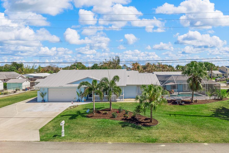 Situated on a spacious corner lot in Stuart's desirable Rocky Point community, this unique property features a 3BR/2BA main home plus a separate 2BR/2BA guest house with private laundry. The expansive floor plan includes a dedicated office, generous living spaces, and a bright Florida room overlooking the screen-enclosed pool and fenced backyard. Enjoy deeded rights to the Pioneer Club with access to a private boat ramp and the Intracoastal Waterway. A rare opportunity to enjoy flexible living and the Florida boating lifestyle just minutes from downtown Stuart, waterfront dining, and beaches.