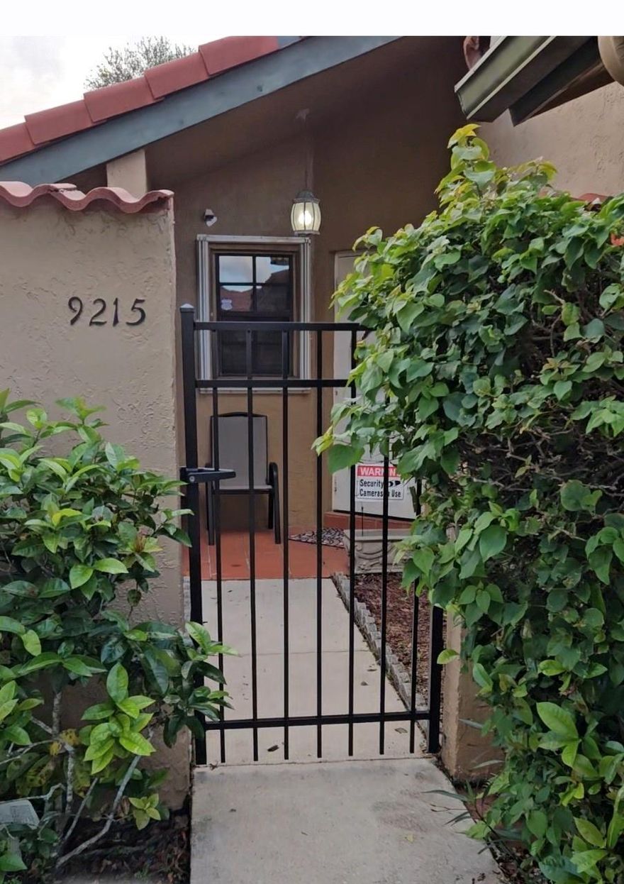 Beautifully updated courtyard villa in gated community. Features tile and laminate flooring, renovated kitchen with stainless steel appliances and wooden cabinets, updated bathrooms, accordion shutters on all windows and doors, and ceiling fans in every bedroom. Includes screened patio, exterior storage, and private gated courtyard. Community offers an intimate clubhouse with pool and a small play area for children - —ideal for families or anyone seeking a welcoming neighborhood..