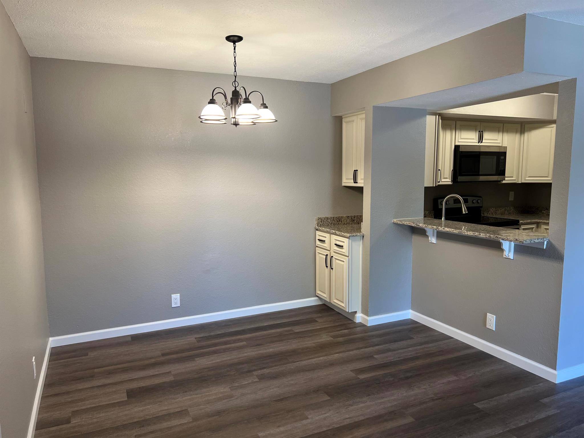 Motivated Seller! Refurbished in 2022 - FIRST FLOOR 2 BED/2 BATH Condo with a modern and sophisticated interior! New Roof 2022. MOVE-IN READY! The kitchen is outfitted with SS appliances, granite surfaces and deluxe cabinetry with soft close drawers. LVP flooring, fresh & neutral color paint, baseboards, lighting fixtures and new fans installed. Bathrooms are brought to life with upscale cabinetry, finishes and hardware. Popcorn Ceilings GONE! Natural sunlight will brighten up your home while a screened patio allows fresh air to flow in. Laundry is a snap with an interior W/D. A community of all ages with a Clubhouse and pool. Walk to the Festivals and Farmer's Markets! Shopping, Dining, Medical, Hospital, Publix and golf all nearby in under 5 minutes. Investors welcomed.