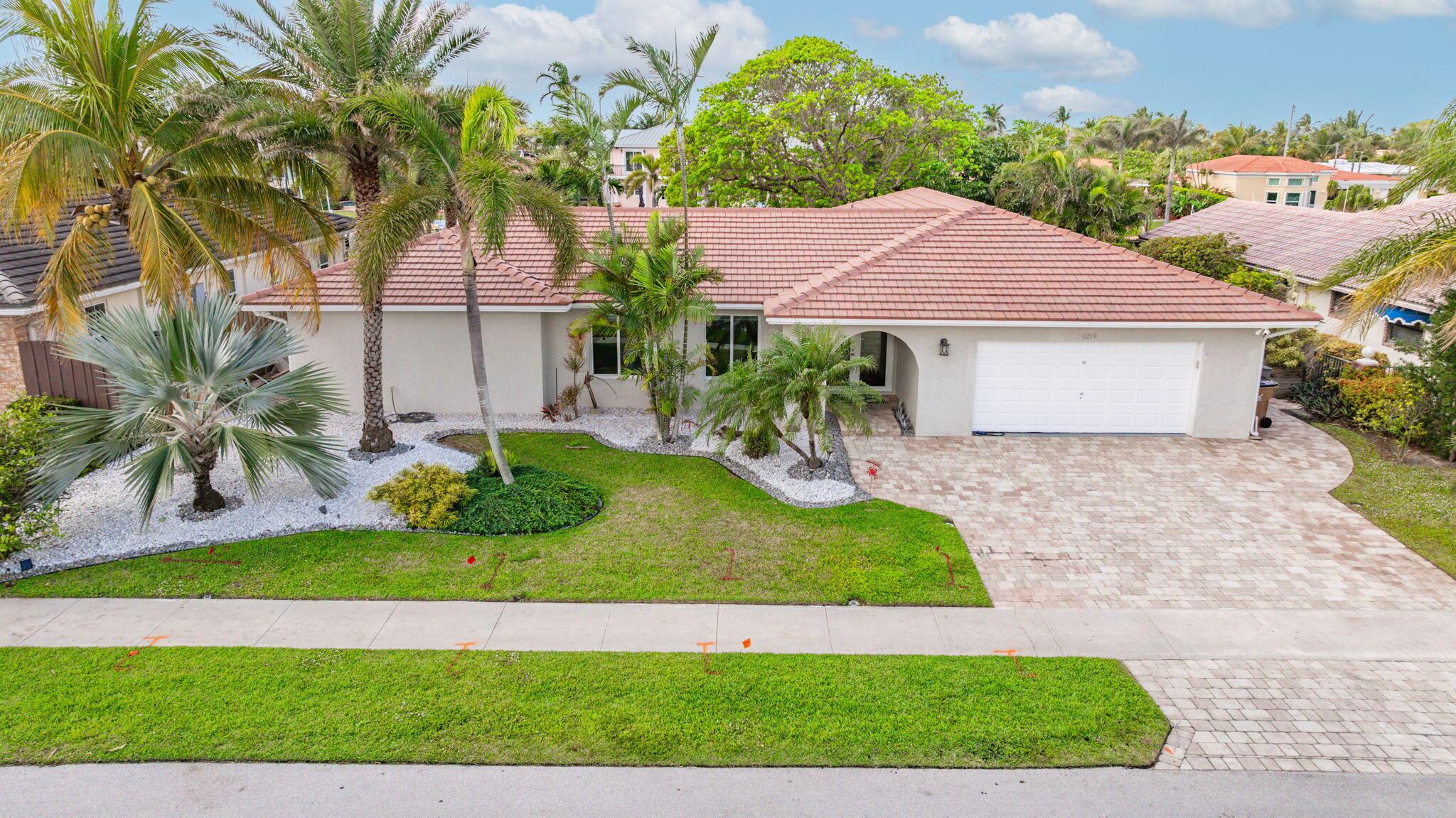 Bring your yacht and walk to the beach from this 90' no-fixed bridge waterfront oasis! Completely renovated in 2016, this home features a spacious open floorplan with 3 large bedrooms, a bonus room perfect as an office or convertible to a 3rd bath, and sleek white porcelain tile throughout. The chef's kitchen boasts a gas stove and top-tier appliances. The property includes a private pool, cabana bath, and a beautifully designed outdoor space with expanded paver walkways, an in-ground firepit, and vibrant landscaping. Upgrades include hurricane-impact windows and doors, a 20,000-pound boat lift, a propane system for the kitchen and BBQ, and an extended driveway. A large 2-car garage with ac completes this exceptional home!