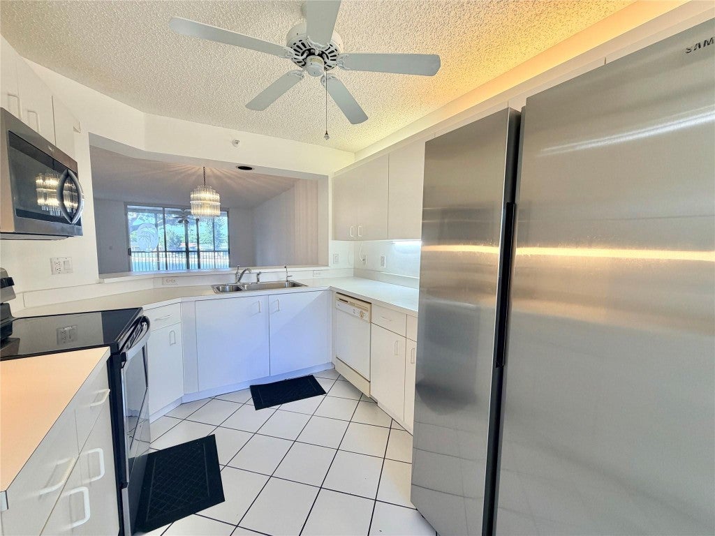 Photo of 9587 Weldon Circle #B204, Tamarac, FL 33321 (MLS # F10532549)