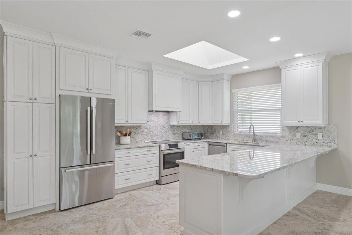 GORGEOUS MOVE-IN READY HOME WITH GOLF VIEWS! Nestled on a beautifully landscaped 1/2-acre lot overlooking the 2nd hole of the prestigious Legacy Golf Course, this meticulously updated home offers luxury, comfort, and peace of mind. Step inside to discover a bright, modern interior featuring 24x24 porcelain tile flooring throughout, a 2018 metal roof, PGT WinGuard impact windows, and a hurricane-rated garage door--every detail designed with quality and durability in mind. The chef's kitchen is a true showstopper, featuring Bosch appliances, granite countertops, custom cabinetry, with an adjacent dining area and family room, perfect for entertaining. The living room offers a more formal gathering space including bar area with wine cooler all with breathtaking views of the golf course. Three