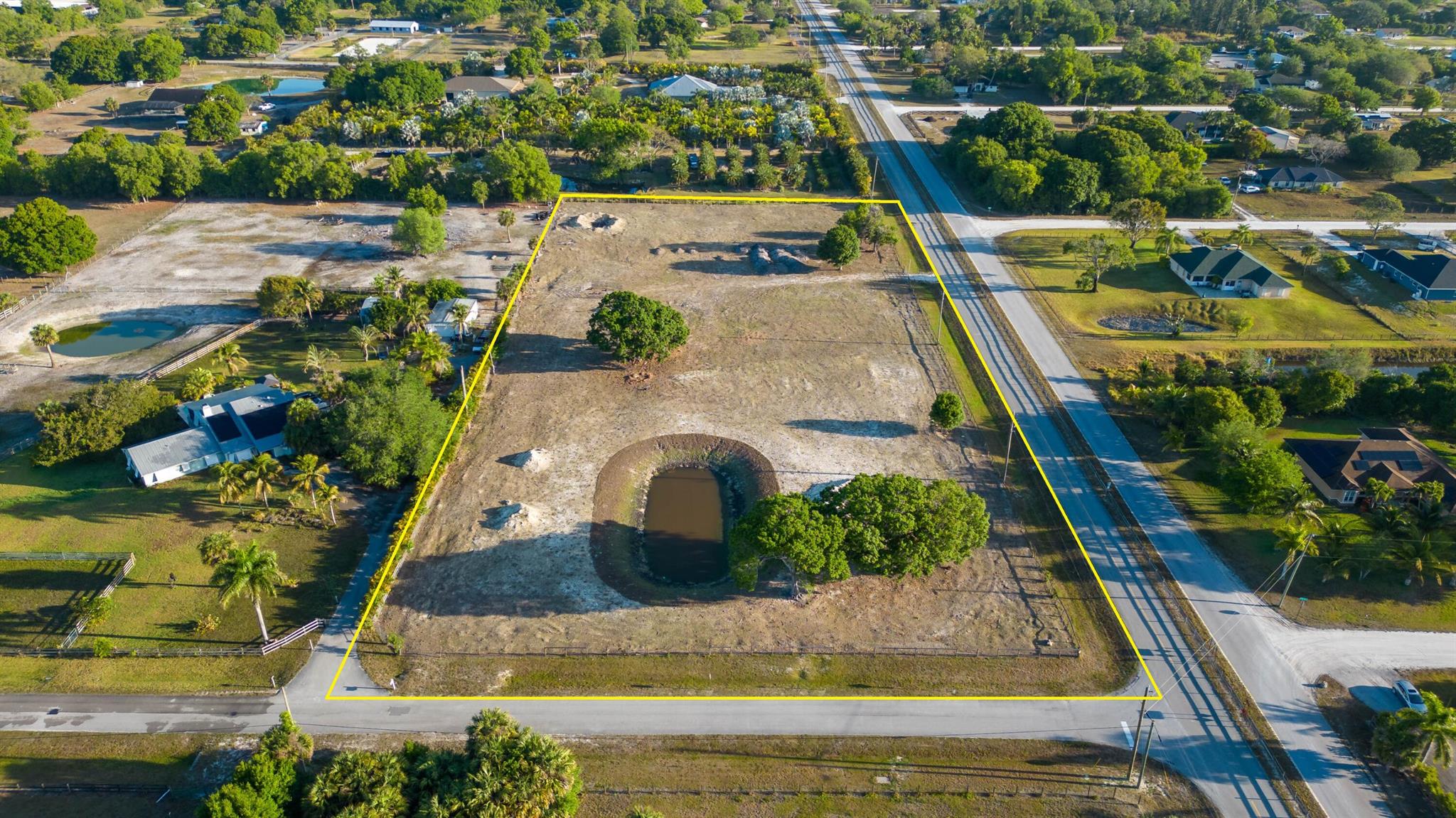 Live the true Lox Life and enjoy the best of all worlds! Nestled away from the hustle-n-bustle but within minutes to the newly built city of Westlake, soon to offer brand-new shopping, entertainment and dining. Easily experience the coastal life with just a short 20-mile drive to South Florida's beaches and turquoise waters. Relax beneath a row of mature Oaks providing ample shade on this majestic 5-acre corner lot equipped with water and electric. The seller has already saved you the time and money by investing nearly $75k for the clearing and filling of the land as well as the repositioning the pond to be perfectly situated with the entrance to your new dream home, with plenty of space to add a barn, workshop, cottage or all! Zoned Agriculture... (see more