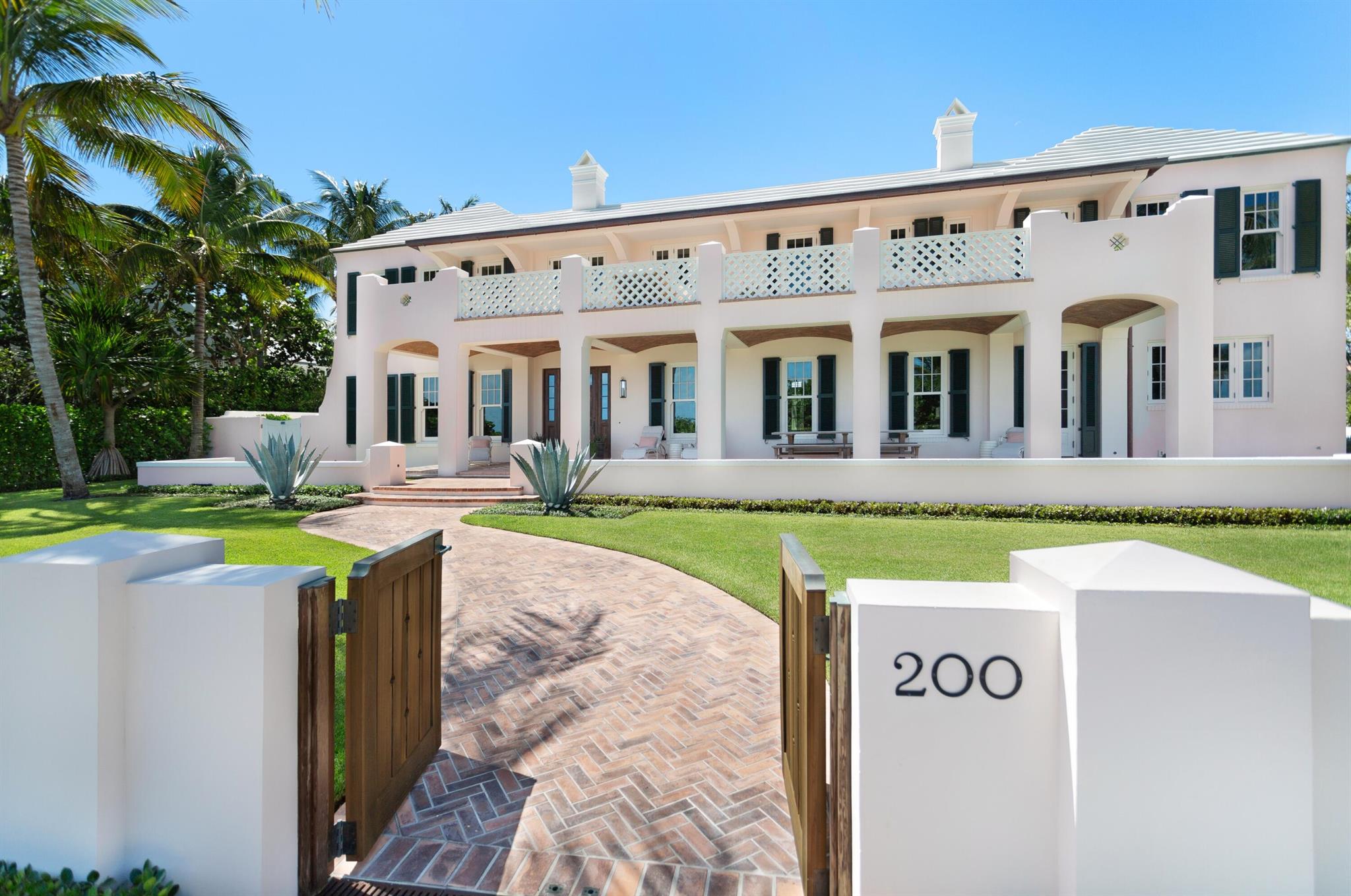 Oceanfront Bermuda beach house in Palm Beach strategically sited on a 20,038 SF parcel with another 21,780 SF on the direct ocean, totaling 41,818SF. This crisp and modern 6 BR home with a hint of patina & floors that sandy feet won't damage was designed by Moor, Baker & Associates, built by Tim Givens Building in 2018. The story of the house is windows, glass doors and all natural materials including the antique oak flooring, cypress doors, zero VOC interior paint, brass, bronze and copper hardware and fixtures soy-based plywood for cabinetry and solid pine floor underlayment just to name a few. The 8,900+ SF home features formal living and dining spaces, a charming, screened porch overlooking the gorgeous pool gardens and cabana with fireplace. Perfect for black tie & barefoot living.