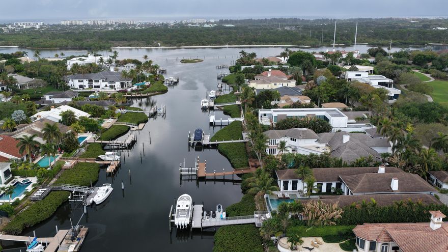 Fantastic opportunity in Admirals Cove on a deepwater lot located just a few homes from the Intracoastal Waterway. This property presents an excellent chance to build your dream home or complete a renovation in one of Jupiter's most desirable boating and golf communities. Spyglass is home to some of the most impressive estates in Admirals Cove, and this presents a chance to create your own. Golf course views in the front and water views in the back further highlight the unique setting of this property.  The interior of the home has already been largely demolished in preparation for renovation, offering a head start for a buyer looking to reimagine the existing structure or start fresh with a new build.  With deepwater access and close proximity to the Intracoastal, this property is ideally and close proximity to the Intracoastal, this property is ideally positioned for boating enthusiasts seeking quick access to open water.  Admirals Cove is known for its exceptional lifestyle and amenities, including 45 holes of championship golf, two clubhouses, two driving ranges, a full-service marina, tennis and pickleball courts, a state-of-the-art fitness center, and multiple dining venues. Residents enjoy a private club atmosphere combined with world-class boating and golf in one of Jupiter's premier waterfront communities.