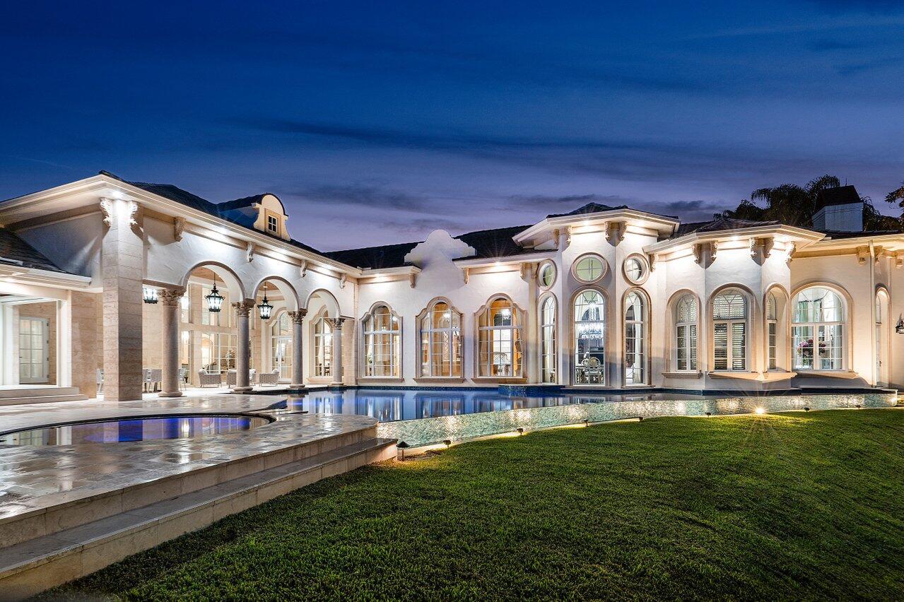 Simply one of the most exquisite homes in prestigious St. Andrews Country Club. This renovated estate is located on a spectacular property of .83 acres (essentially comparable to a triple lot in the community). This extraordinary property includes a winding driveway around a central fountain; a tree canopy of beautiful, mature live oaks; and expansive east facing water views. Combining European elegance with modern technology and convenience, this residence provides approximately 9000 square feet under air and has five bedrooms (all ensuite), six full and two half baths. This comfortable layout is entirely on one level, excluding two of the large guests suites which comprise the second floor. The home features a magnificent office, a six (6) car air-conditioned garage,