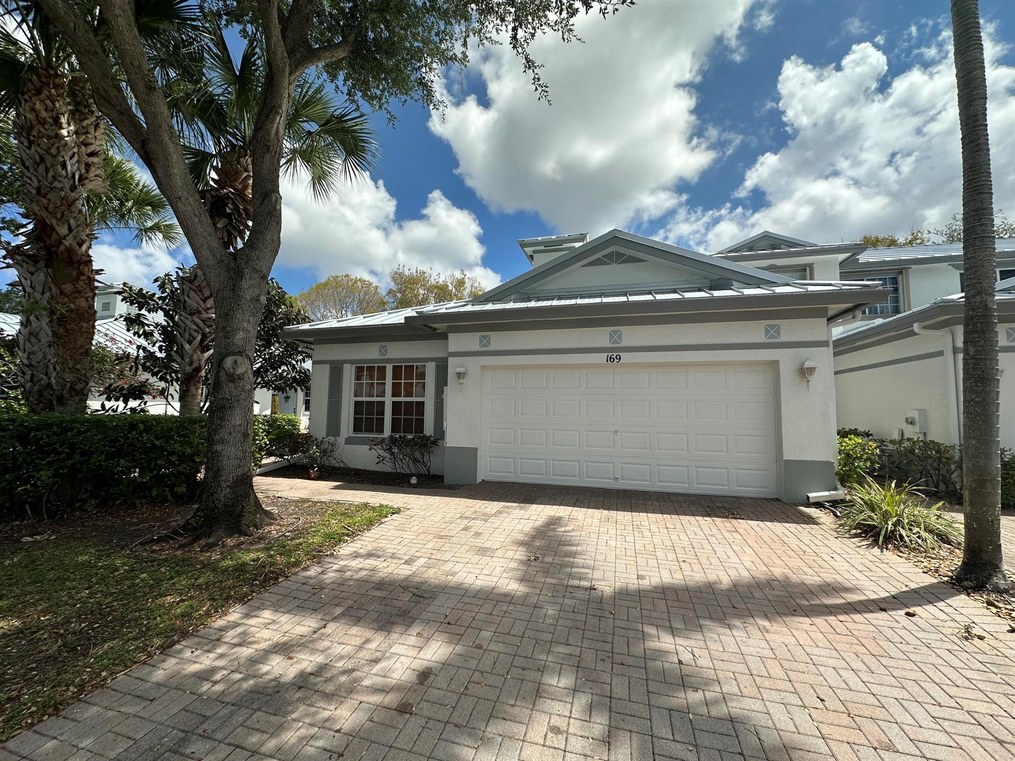 Welcome to your corner of paradise at Coconut Key! This charming villa offers the perfect blend of comfort and convenience, boasting 2 bedrooms, plus a den, and 2 baths alongside a spacious 2-car garage. As you step inside, you'll be greeted by the airy ambiance of volume ceilings complemented by the warmth of wood laminate flooring in the main living areas. The kitchen has stainless steel appliances and a full-size washer and dryer. Imagine unwinding by the community pool or shooting hoops on the basketball court. With basic cable included, you'll stay entertained effortlessly. But the real charm lies in the location - nestled within the gated Coconut Key community, just off the bustling Atlantic Avenue in Delray Beach.