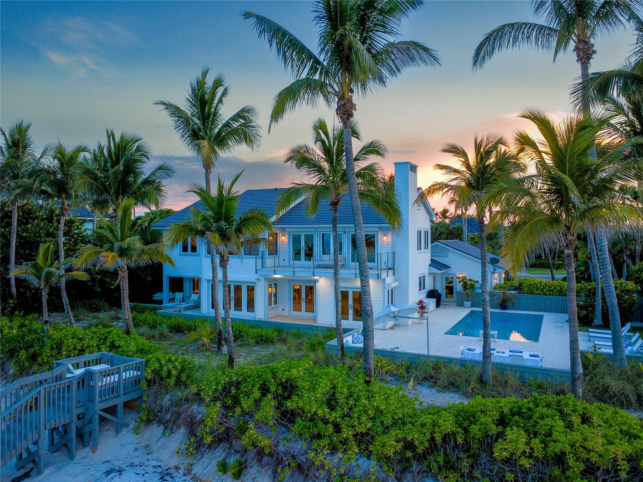 Turnkey oceanfront estate in the prestigious guard-gated community of Seagrove. Renovated by Croom Construction in 2012 with lifetime raised aluminum roof, impact glass, and electric storm shutters. Featuring 120 ft of private beachfront, floor-to-ceiling windows, and an open concept layout ideal for entertaining. Two elegant primary suites and sunlit living spaces create a seamless indoor-outdoor flow. Minutes from Vero’s upscale dining, boutique shopping, and cultural venues. A rare opportunity to own a refined coastal retreat in one of Vero Beach’s most sought-after enclaves. Move-in ready and meticulously maintained, with lush tropical landscaping, generous outdoor living spaces, and timeless architectural charm.