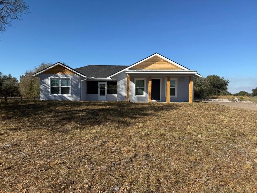 Welcome to this brand-new 3-bedroom, 2.5-bath custom home situated on 1.25 acres in scenic Okeechobee County. A unique courtyard-style home, it features a private, covered central courtyard that connects the main living area to the guest bedroom wing, blending indoor comfort with outdoor living. The main house offers an open-concept living and dining area that flows seamlessly into a modern kitchen with stainless steel appliances and wood countertops. Also located in the main house are a half bath and a spacious master suite, complete with double sinks, dual shower heads, and a large walk-in closet. All rooms in the main house provide direct access to the courtyard, creating a seamless indoor-outdoor experience. Across the courtyard are two additional bedrooms and a full bathroom, each with its own access to the courtyardideal for guests, family members, or a private home office setup. Additional highlights include barn doors, a covered front porch, washer and dryer included, and a fully fenced yard with gate for added privacy and security. Located on NW 288th Street, this home offers peaceful country living while remaining conveniently close to shopping, schools, and US-441. More pics coming soon!