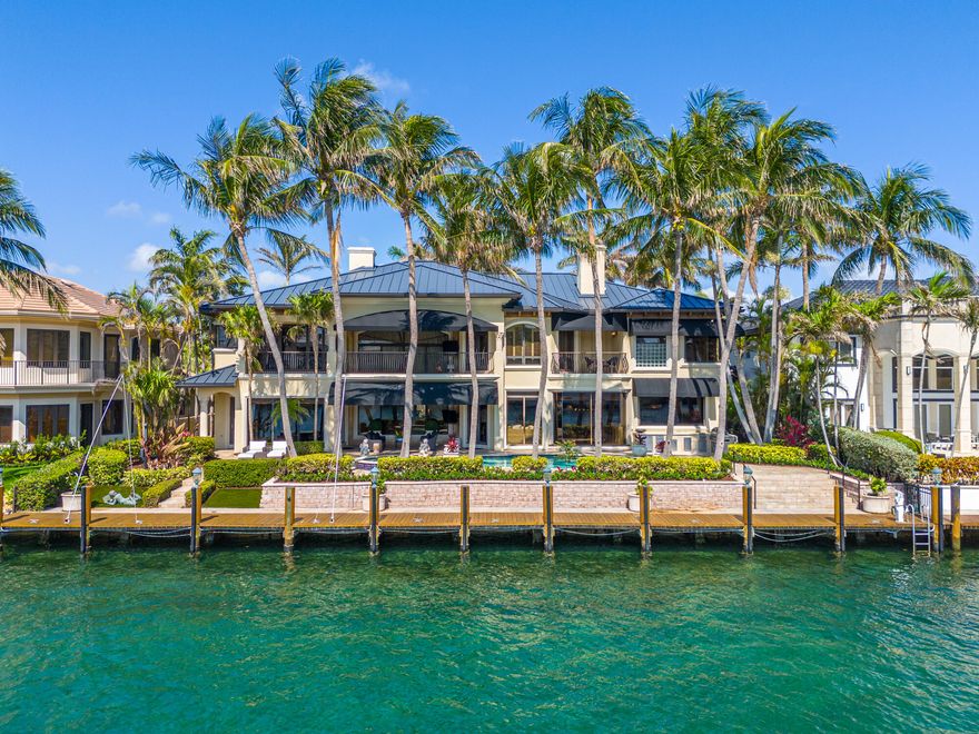 Lifestyle, location, luxury - This exquisite and sophisticated Custom Estate home is a rare, prized property on the direct Intracoastal No Wake Zone with ample room to dock a 100' vessel, within minutes to the Hillsboro Inlet and direct ocean access. Encompassing 6789 square feet exemplifying the grandeur of luxurious living. The home has been crafted to impress. Flawless design, unparalleled construction & craftsmanship elevate this gated, 6 bedroom, 6.5 bath home complete with a media room providing a perfect panoramic experience of the best views living on the water  has to offer. An abundance of natural light from the many floor to ceiling windows captures the idyllic views of the Intracoastal and Hillsboro Mile Millionaires' Row.  Several inviting gathering areas inside and out unveil the quiet and beautiful ambiance of the home. The grand Foyer complete with 24' ceiling beckons you to step inside.  The exquisitely appointed formal living room with gas fireplace is the perfect place for entertaining or relaxation. An elegant and graciously sized formal dining room is adjacent to the living room. The well appointed kitchen offers beautiful wood cabinetry, high-end appliances, a custom walk-in pantry, and a separate butler's pantry with wet bar. A handsome wood-paneled family room with a fireplace enjoys glorious water views. The fun continues while the family enjoys movie nights in the dedicated media room. And, the private office is sure to inspire productivity.  Ascend the magnificent staircase to the second floor, or take the elevator upstairs to the primary suite offering a gracious bedroom with east facing views, a sitting room with a wet bar, and his and her baths that have been elegantly finished. Generously sized, the three upstairs guest  bedrooms feature walk-in closets and en-suite baths. 
The waterfront loggia features expansive entertaining areas with breathtaking views of the Intracoastal Waterway.  Guests will enjoy the oversized heated pool and spa, lounge on the sun shelf, or gather by the summer kitchen to enjoy alfresco dining at this resort style retreat. EV Station located in the 3 car garage. Minutes to the Hillsboro Inlet and direct ocean access. Available for immediate occupancy.