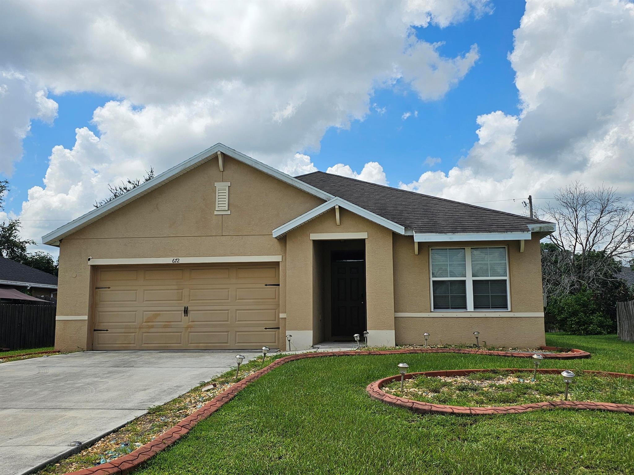 Spacious S/F home with modern touches throughout! 3 B/R, 2 BA, 2 car garage with over 1,600 sq ft of living space. Desirable split floor plan. This home features a bright open kitchen w/island, pantry, and a full appliance package - perfect for everyday living and entertaining. Enjoy luxury vinyl tile in the main living areas, ceramic tile in bathrooms. Convenience of an interior washer and dryer. The master suite offers a walk-in closet, dual vanities, a separate water closet, and a step-in shower. Sliders from the dining area lead to a covered porch, ideal for relaxing outdoors. Option to rent furnished or unfurnished. Prime location - just 12 minutes to I-95 and the Florida Turnpike. Walking distance to schools and parks. 5 minute to shopping and dining. Close to medical facilities.