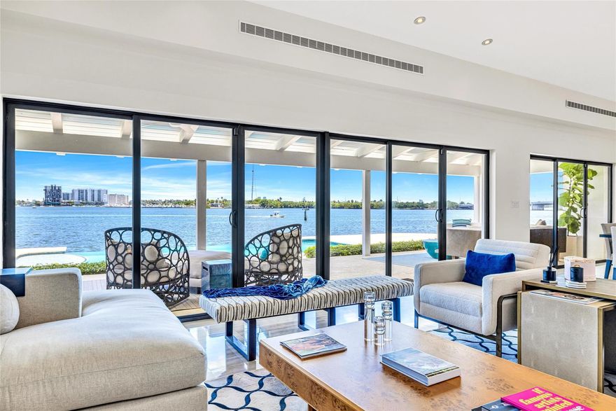 Contemporary 5,768 SF residence on a gated 27,000 SF Southeast Point Lot with 285 FT of premium waterfrontage - 150 FT directly on Biscayne Bay plus 135 FT of protected side canal dockage with dock & boat lifts. Amazing Bay Views from every room, skylit interiors, and seamless indoor outdoor flow to a covered porch, infinity edge pool & expansive terrace. The 1,240 SF primary retreat and three en-suite guest rooms each offer private outdoor access plus there is an office and a fifth en-suite bedroom. Quiet cul-de-sac location with quick access to top schools, major venues, the Design District, beaches, and the airport. A rare waterfront estate offering room to live beautifully today, with protected dockage and the kind of long term value only a premier Miami shoreline can deliver. Biscayne Bay | Impact windows & Sliders | Limestone and 24" Porcelain tile floors | Primary Bathroom - Wetroom, double sinks | Bedroom #2(also possible primary) Bathroom Wetroom, double sinks | Outdoor cabana full bathroom with shower | Pool decking 1500 SF | Alarm System | 2006 Roof Concrete tile gable roof | 3 HVAC units | Two 175 AMP GE Main Breakers | 200 AMP Sieman Main disconnect on Exterior | Two 2012 50 gallon American water heaters | Outdoor Storage room | 33 ft dock | Two 10,000 lb boat lifts | Crawl Space access for approx 1/2 of the house | Room for expansion | One of the two cul-de-sac point lots (SE point a total of two lots 19,375 SF + 7623 SF= 27,000 SF | Minutes to the Design District, Wynwood, Bal Harbor Shops, great dining and Miami Beach.