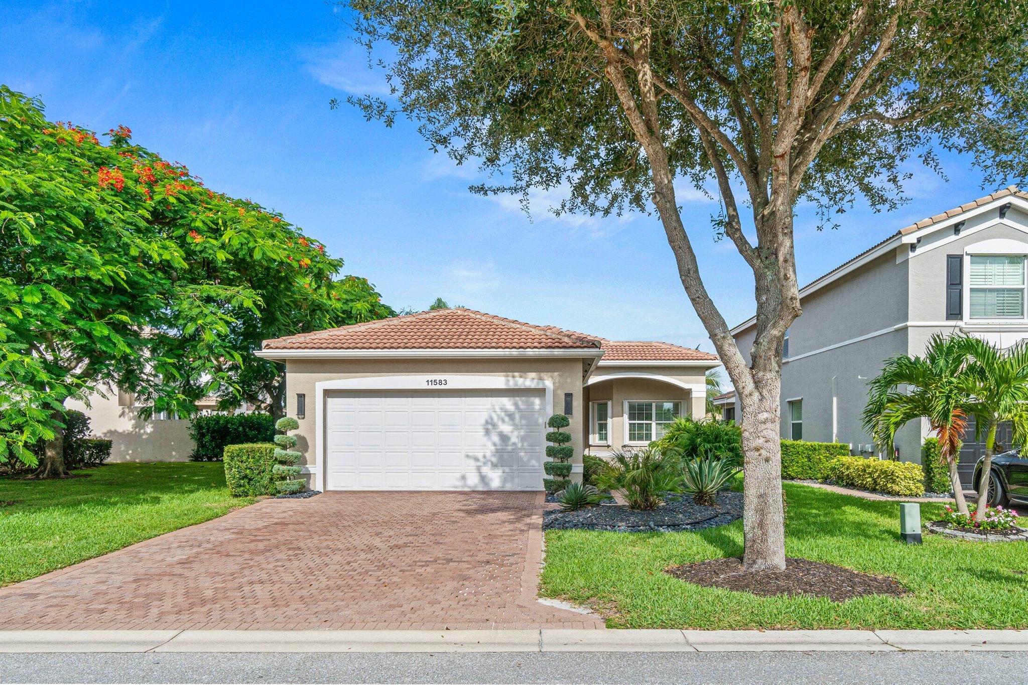 Take in breathtaking lake views in this beautifully renovated open-concept home. The kitchen features white cabinetry, quartz countertops and backsplash, pull-out drawers, an oversized island, and a spacious pantry with custom shelving. The family room overlooks serene sunsets, complemented by a formal dining room ideal for entertaining. Double door den off the foyer. The primary suite offers a Roman tub, separate shower, dual vanities. Additional upgrades include custom closets in all 3 bedrooms, designer lighting and fans, lush landscaping, and luxury vinyl flooring throughout. The laundry room is complete with custom cabinetry. Additional features include crown molding, accordion shutters, an extended driveway on an easement lot, epoxy-coated garage floor, overhead storage, EV Charge