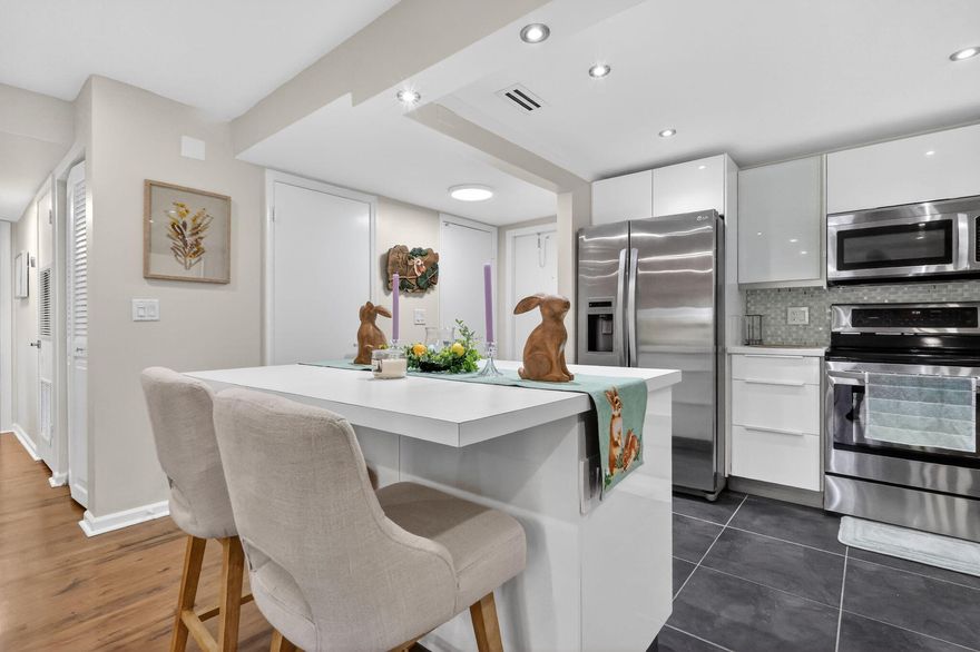 Tastefully upgraded condo featuring an open floor plan with 2 bedrooms, 2 full baths, 2 walk-in closets, and a half bath, located in the gated community of Shoreside on the Intracoastal. This corner unit on the 2nd floor offers a spacious balcony and has been beautifully renovated, has impact windows. The open kitchen includes white cabinetry, stainless steel appliances, a pantry, and an island. Wood flooring in the living areas and bedrooms, with tile in the kitchen. Stackable washer and dryer are inside the unit. Maintenance includes water. The community offers a pool, sauna, and brand-new dock along the Intracoastal, and is conveniently close to restaurants, marinas, and beaches. The association does not allow pets and requires a minimum 700 credit score. Can be rented at once!