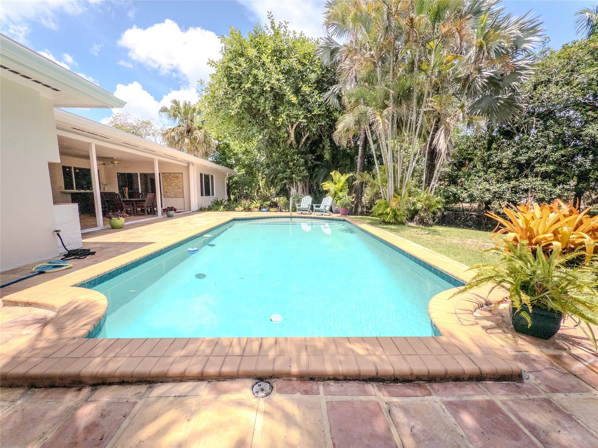 Tropical paradise meets modern comfort in this stunning 4-bed, 3-bath pool home on a quiet Oak Lined street in East Plantation! Enjoy easy living with ***High Speed Internet, Lawn, Pool included***. Enjoy over 2,200 sq ft of indoor living plus covered Lanai and with over 18,000 sq ft of outdoor space with triple sliding doors that open to a massive covered lanai, outdoor BBQ, and lush, fully fenced yard. Sit pool side and watch the ducks swim by. Two ensuite bedrooms on opposite sides offer privacy. 3 walk-in closets and tons of storage. Bright open layout with natural light, huge windows (partial impact), and gorgeous views from every room. Conveniently located near Top Rated Schools, Plantation Walk, Heritage Park, Shopping, dining, and just minutes to 595 and the airport! 6-12 m welcome