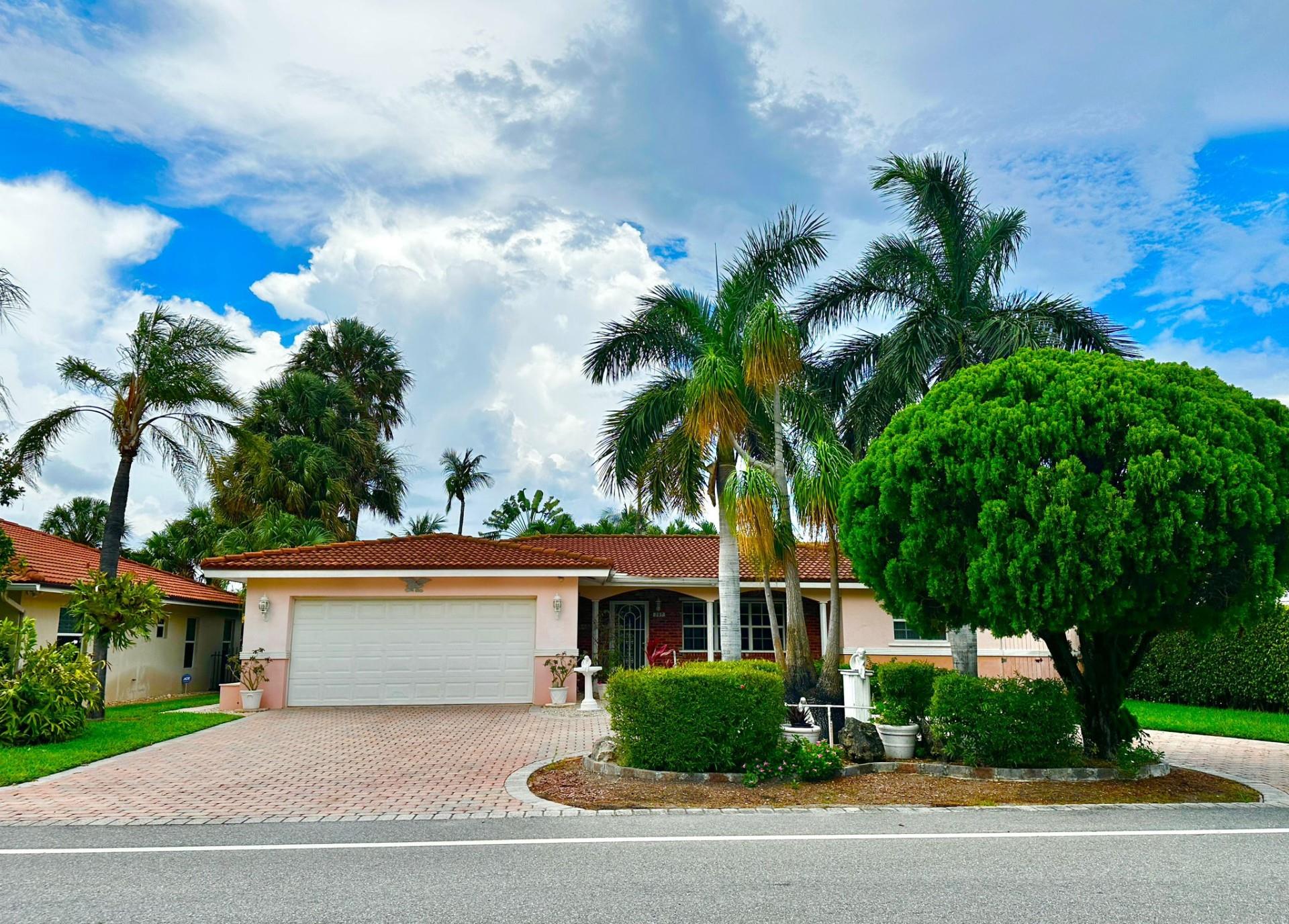 Your Beachside Retreat in Palm Beach Shores. Welcome to this inviting 3 bd/2 bath home, located in the heart of Palm Beach Shores, two blocks to the beach, world-class diving and snorkeling at Phil Foster Park, and the inlet with easy ocean access from the Intracoastal Waterway. This home offers an open-concept layout, a split floor plan, and a spacious primary suite featuring its own private bath and walk-in closet. A bright and welcoming family room is a perfect spot for gatherings, movie nights, or simply enjoying views of the tranquil garden. A cozy front porch, a 2-car garage with storage cabinets & overhead shelving for all your gear, bikes, and beach toys, as well as a circular paved driveway that makes coming and going a breeze.