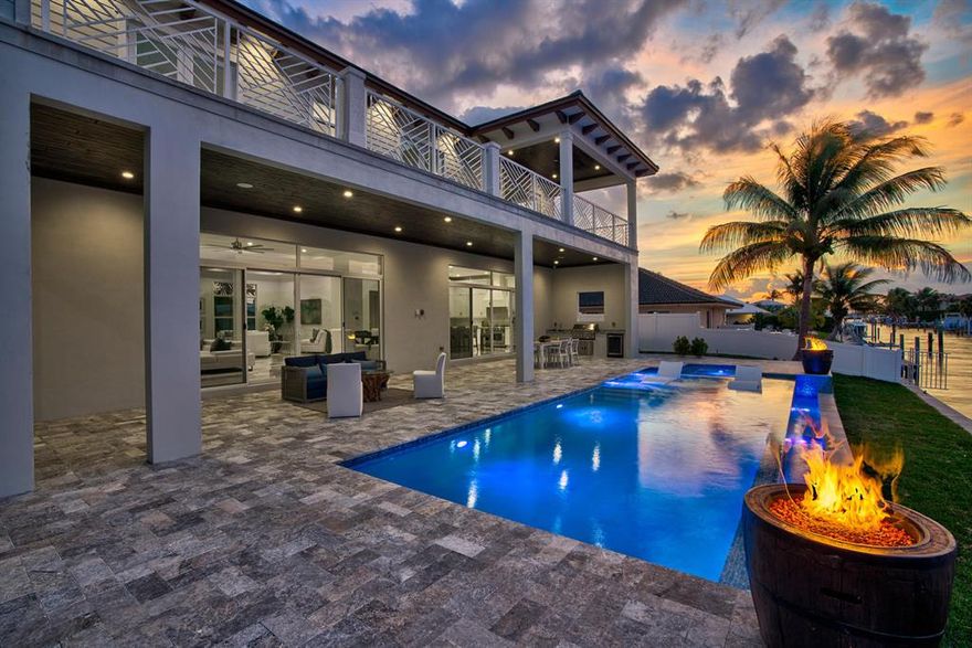 Bring your big yachts and boats. Quality was our first consideration when designing and building this brand new contemporary masterpiece on over a 100' lot, directly on a wide deep water canal, with quick ocean access. Great home for large or multiple boats.Home has 10k LB boat lift Walk through the front door to a beautifully open and versatile great room with gorgeous tall ceilings and crown molding. The home was installed with impact-resistant, tinted windows and sliding doors. Upon opening the sliding doors you view the magnificent infinity pool and spa. If staying indoors, simply relax in this tranquil 5000 square foot living area under air