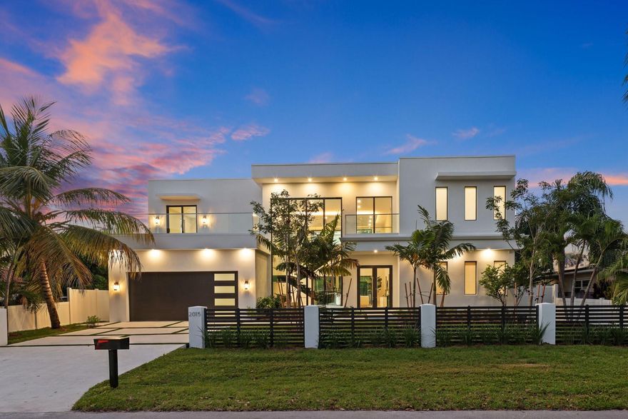 PRICED TO SELL! Modern elegance & architectural sophistication define this Wilton Manors home spanning 3,755 SQFT with 4BD, 4.5BA, & 2-CG. Featuring a floating glass staircase, private elevator, and soaring 24' ceilings, Filled with natural light. Italkraft cabinetry, quartz countertops, Miele appliances, and wine cooler complement the sleek interior. Two identical primary suites—one on main level & additional upstairs—plus two guest bedrooms connected by an enclosed glass catwalk overlooking the living area. Additional features include prewired sound system, stackable washer/dryer upstairs, full laundry room on main level, surrounded by tropical landscaping with an outdoor kitchen, saltwater spa and lap pool with waterfall feature. Designed & Built by Atlantic Group Developers.