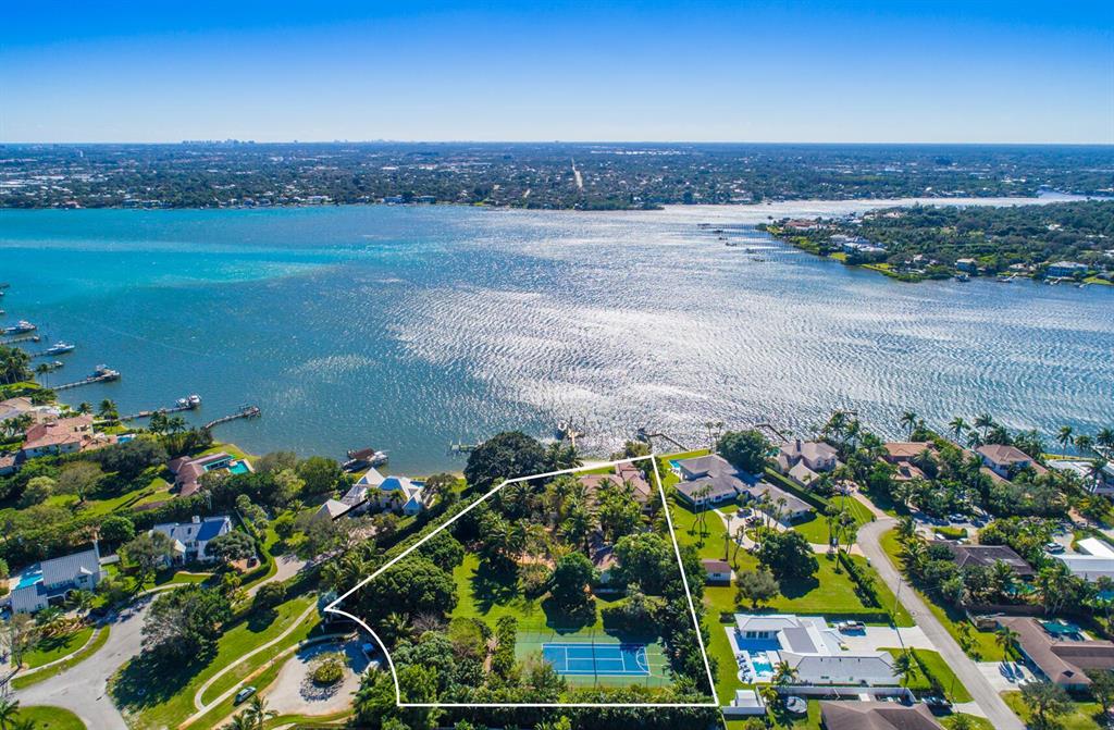 Tranquille Riverfront compound on 2.2+ acres with the widest and most panoramic views along The Loxahatchee River in the exclusive Anchorage Point of Tequesta! This over 10,000 total sf home features 6 bedrooms, 8 bathrooms, 2 main living areas, library, den, separate guest house with additional 2 bedrooms and kitchenette/living area, large 3 car garage with workshop, tennis court with plenty of room to add additional structures. The main home was re-constructed with a total and complete addition and renovation in 2011! As the only home on the circular private street, the property boasts a private sandy beach, long dock with 20k boat lift, and the expansive outdoor living with a great summer kitchen and bar area looking south down the river. Other outdoor features include a spa-like