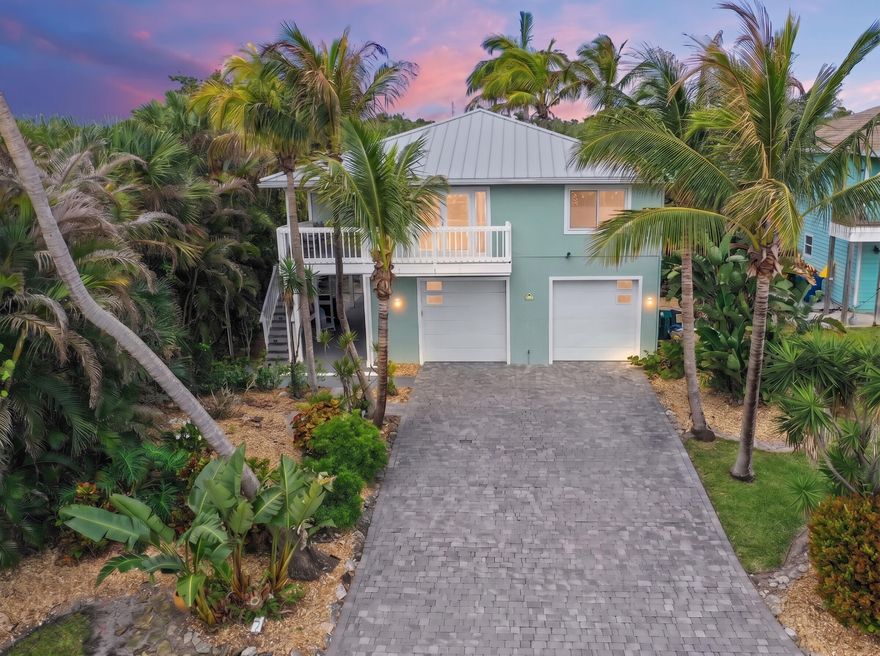 Rare island opportunity! This turnkey 2-unit multifamily gem on Hutchinson Island sits just two blocks from the beach and steps from vibrant dining, nightlife, and boating. Unit 1 (upstairs) boasts stunning ocean views, 2BR/2BA, a island kitchen with granite counters, SS appliances, and a gas range. Unit 2 provides a private 1BR/1BA retreat.  Extensive upgrades include impact windows, a 2021 metal roof, and lush tropical landscaping with room for a pool. Enjoy the coastal breeze from the covered balcony or patio. Includes 2 garage spaces (possible add 3rd unit), laundry, and comes fully furnished. Successfully operated as an Airbnb for nearly 3 years with financials available. Whether you're looking for a premier short-term rental or a dual-living beach escape, this property delivers.