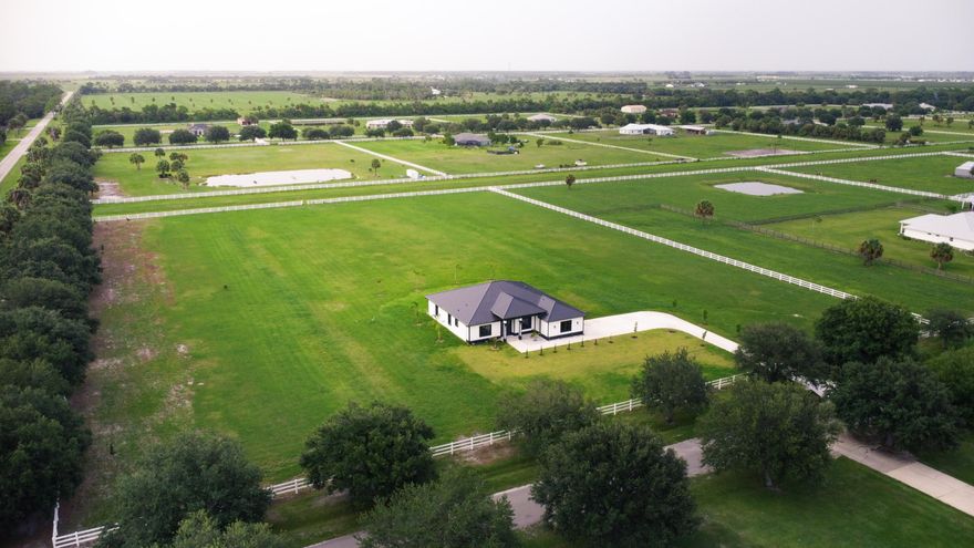 A New Construction, Custom Made Home. With quality building materials, quartz counter tops, metal roof, impact windows/doors, spray foam insulation, and on.  Ready to move in, enjoy a peaceful 5 acres of equine property.  Close to St.Lucie County Fair Grounds. Ten minutes away from I-95 and Turnpike. Not only is it a beautiful property, it is also in a wonderful location in close proximity of many upcoming developments near Midway Road. All the while maintaining distance from the city noise. Part of a Neighborhood association with trails for walking, or horse riding.