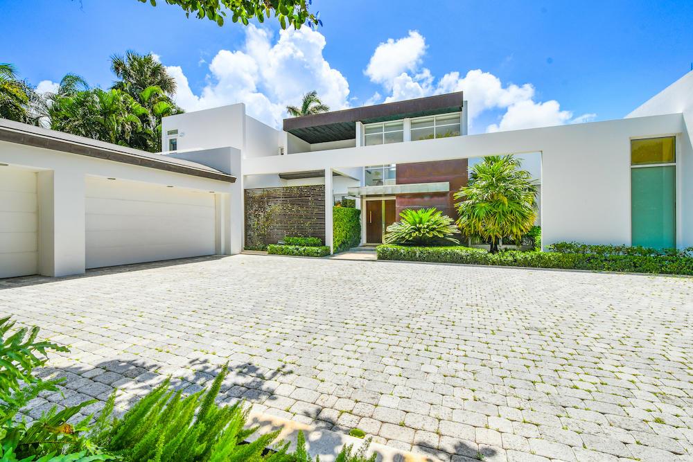 Rarely available on the North End, beautiful, architecturally designed 7,000 +/- sf home boasts 118' on a high elevation with sweeping views of the Intracoastal. No expenses were spared on this spectacular, modern house designed by Mojo-Stumer Architects and built by Worth Builders. The house showcases a grand living room with double height ceilings, custom kitchen, first floor master suite, which includes his and her's bathrooms, closets and offices, and an outdoor area surrounded by lush landscaping and a pool, ideal for entertaining. The custom stone, steel, and wooden staircase floats above the foyer and takes you to the second floor with an additional 4 guest suites. Enjoy unobstructed views of the Intracoastal with full privacy from this very special home.