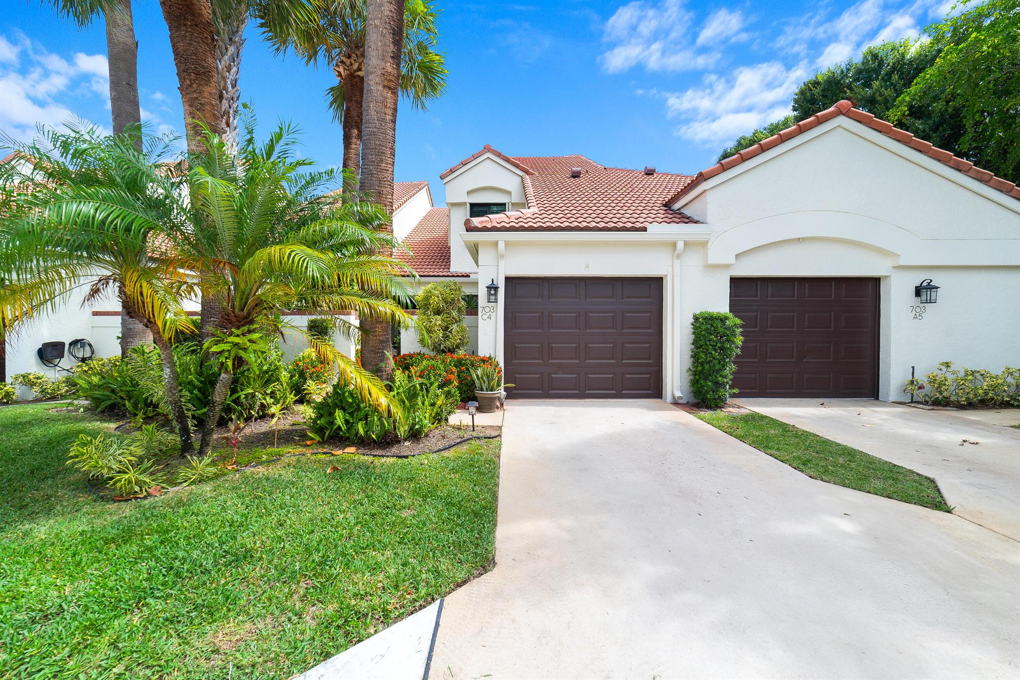 LOCATION, LOCATION, LOCATION!! WALK TO THE BEACH!! This beautifully maintained and thoughtfully upgraded residence offers a bright, open interior with vaulted ceilings, plantation shutters, and porcelain tile flooring throughout the main level, complemented by new carpet upstairs. A complete home renovation in 2016 included new light fixtures, ceiling fans, and the removal of polybutylene piping and the original water heater. The spacious layout features lofty two-story main-level living. Entry through the private courtyard which leads to an open floor plan that flows seamlessly to the rear screened patio and pool area with a privacy wall--ideal for both relaxing and entertaining. Additional upgrades include a new HVAC system (2021),