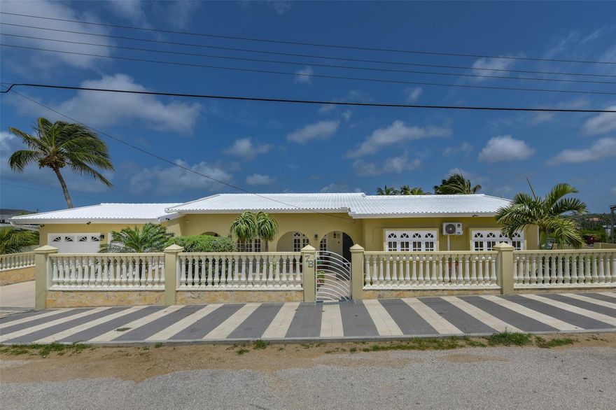 Welcome to Bringamosa 7-B, a charming family home nestled in Aruba’s peaceful countryside, just 20 minutes from the beaches of Eagle and Palm Beach. This well-maintained property offers 3 bedrooms, 2 bathrooms, an open-concept living area, and a spacious kitchen. A big plus is the fact that this property has SOLAR PANELS thus significantly lowering the energy bill. Enjoy the island breeze from your patio, surrounded by mature tropical landscaping. There is also a freestanding 1-bedroom apartment—perfect for visiting guests or generating income through Airbnb. The large lot provides space for expansion or a future pool. Located in a quiet residential area with easy access to main roads, shops, and schools, this property is ideal as a family home, vacation getaway, or investment opportunity.