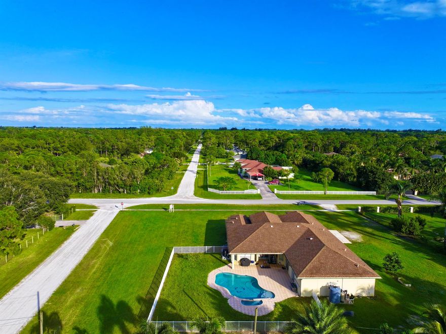 Location **. Location **. Location **   !!  no hoa !! 1.36 acres !!!  4865 total sq ft !! 7 bedroom 4bathrooms 3 car garage , fenced pool  with 2 master suites, lots of  walk in closet space, and abundant natural light !!!   WELCOME TO YOUR PRIVATE PARADISE IN THE HEART OF LOXAHATCHEE !!  THIS STUNNING CUSTOM-BUILT ESTATE AT 6613 HALL BLVD PERFECTLY BLENDS MODERN COMFORT WITH SERENE COUNTRY LIVING ON A SPACIUOS 1.36-ACRE LOT !!  SURROUNDED BY LUSH TROPICAL LANDSCAPING AND NICE HOMES- THIS PROPERTY OFFERS THE PEACE AND PRIVACY YOU'VE BEEN  SEARCHING FOR - WHILE STILL BEING MINUTES FROM SHOPPING, DINING, AND TOP-RATED SCHOOLS.  STEP INSIDE AND DISCOVER SOARING CEILINGS, AN OPEN-CONCEPT LAYOUT, AND ELEGANT FINISHES THROUGHOUT.