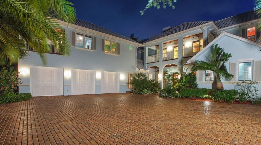 Beautiful, British West Indies estate home situated on a 2/3 acre, blue water home site with unbelievable views of the Loxahatchee River, spacious backyard and white sugar sand beach. Features of this waterfront paradise include formal living & dining rooms and a chef's kitchen (which overlooks the spacious family room) equipped with a large prep island, granite countertops & top-of-the-line stainless steel appliances. There are 4 bedrooms within the main home, all with private baths, 2 office/dens & gym, plus 1BR/1BA guest quarters with a kitchen. Quality features include hardwood floors, custom volume ceilings, detailed moldings,     hurricane impact windows & doors and a standing seem metal roof. The spacious, covered patio includes a summer kitchen and overlooks the pool and river!