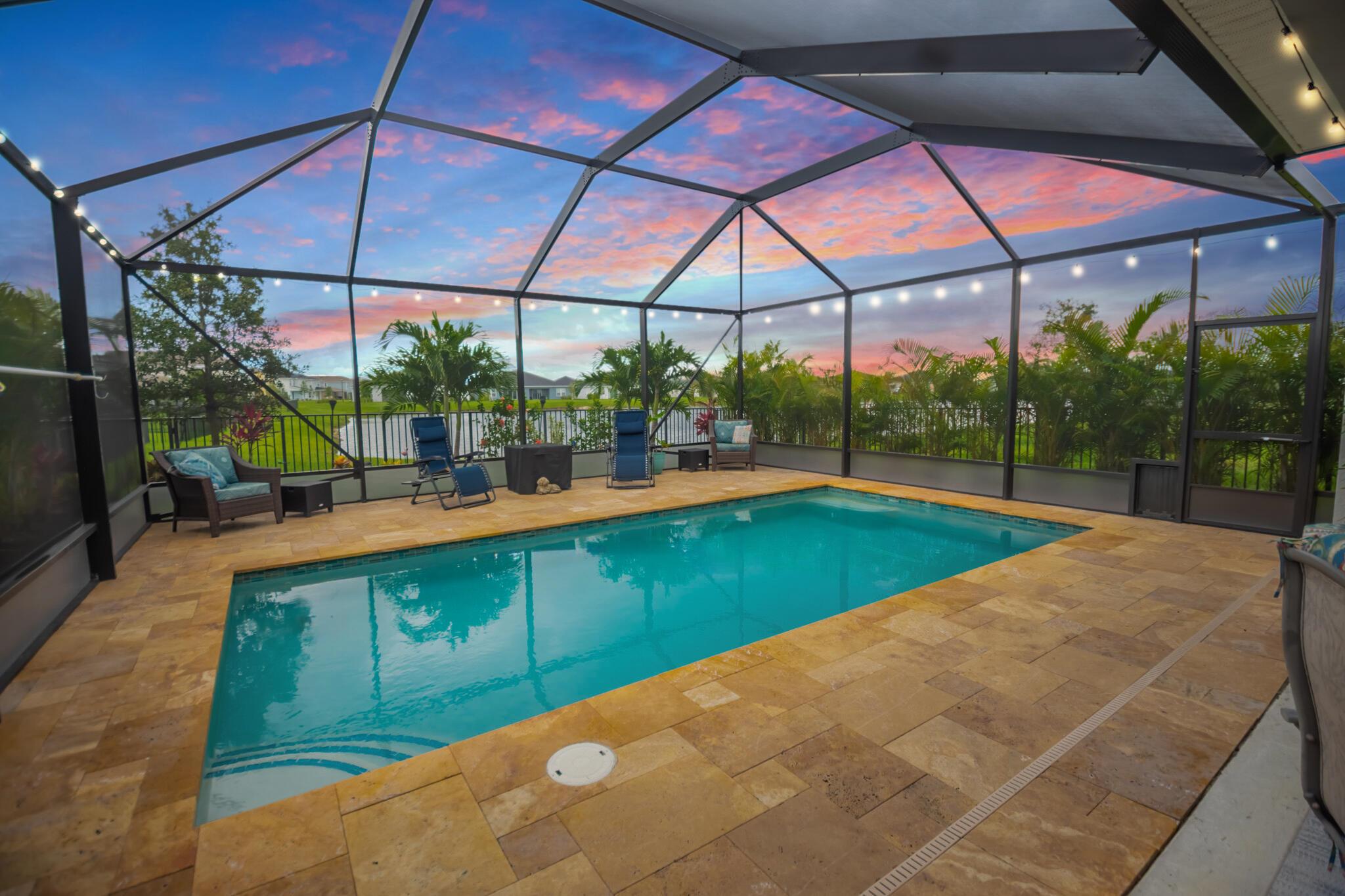 Lakefront luxury meets functionality in this stunning 4BR/3BA/2CG two-story pool home with flex room in Central Park at Tradition! Enjoy a saltwater heated, screened pool with travertine deck and covered lanai--your private oasis. The first floor features an open living area, full bath, gourmet kitchen with granite counters, wood cabinetry, pantry, cooktop, double oven, and stainless appliances. Upstairs offers a spacious loft, laundry room, and four generous bedrooms. Low HOA includes resort-style pool, dog park, and more.