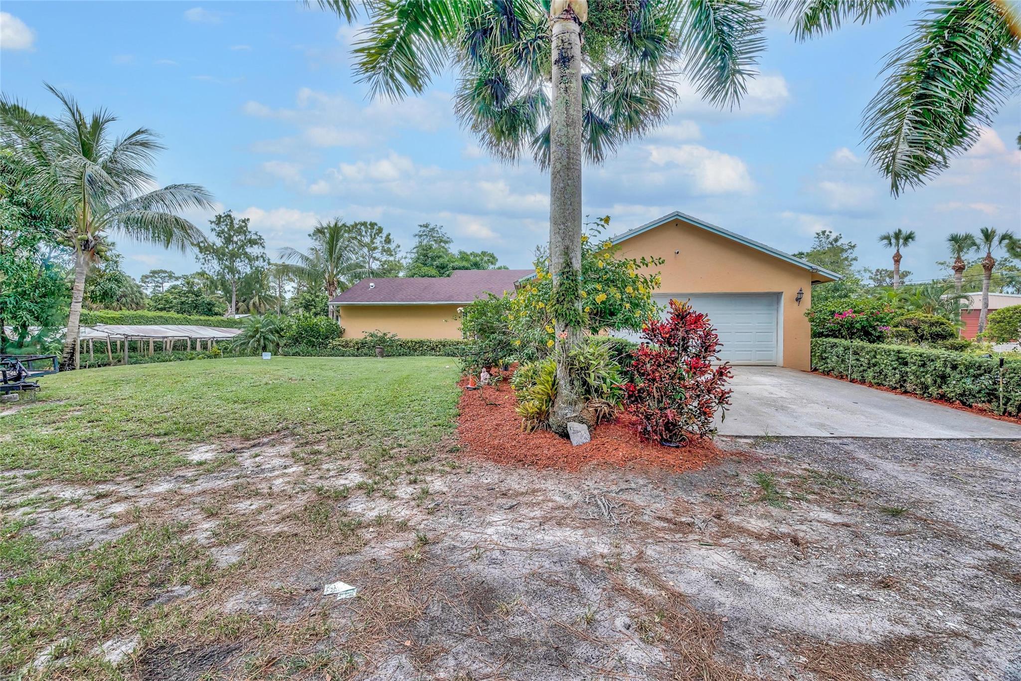 This 3 bedroom/2 bathroom home sits on on a large 1.29-acre lot with matured ficus trees surrounding the property. In addition to this you have a terrace being utilized as a 4th bedroom, that offers alternative usages for it. The master bedroom features both a walk-in closet and a bathroom. The living room and dining area feature high ceilings. It also features 2 garages and a spacious driveway for plenty of parking. A newer roof and air conditioning system were recently installed. With such ample space, the home offers great opportunity for growth both with the home and the expansive yard. Such things as shopping centers and major highways, such as the turnpike and I-95, are in short distance. With no HOA fees and endless opportunities, this home is ready for someone new to call it home.