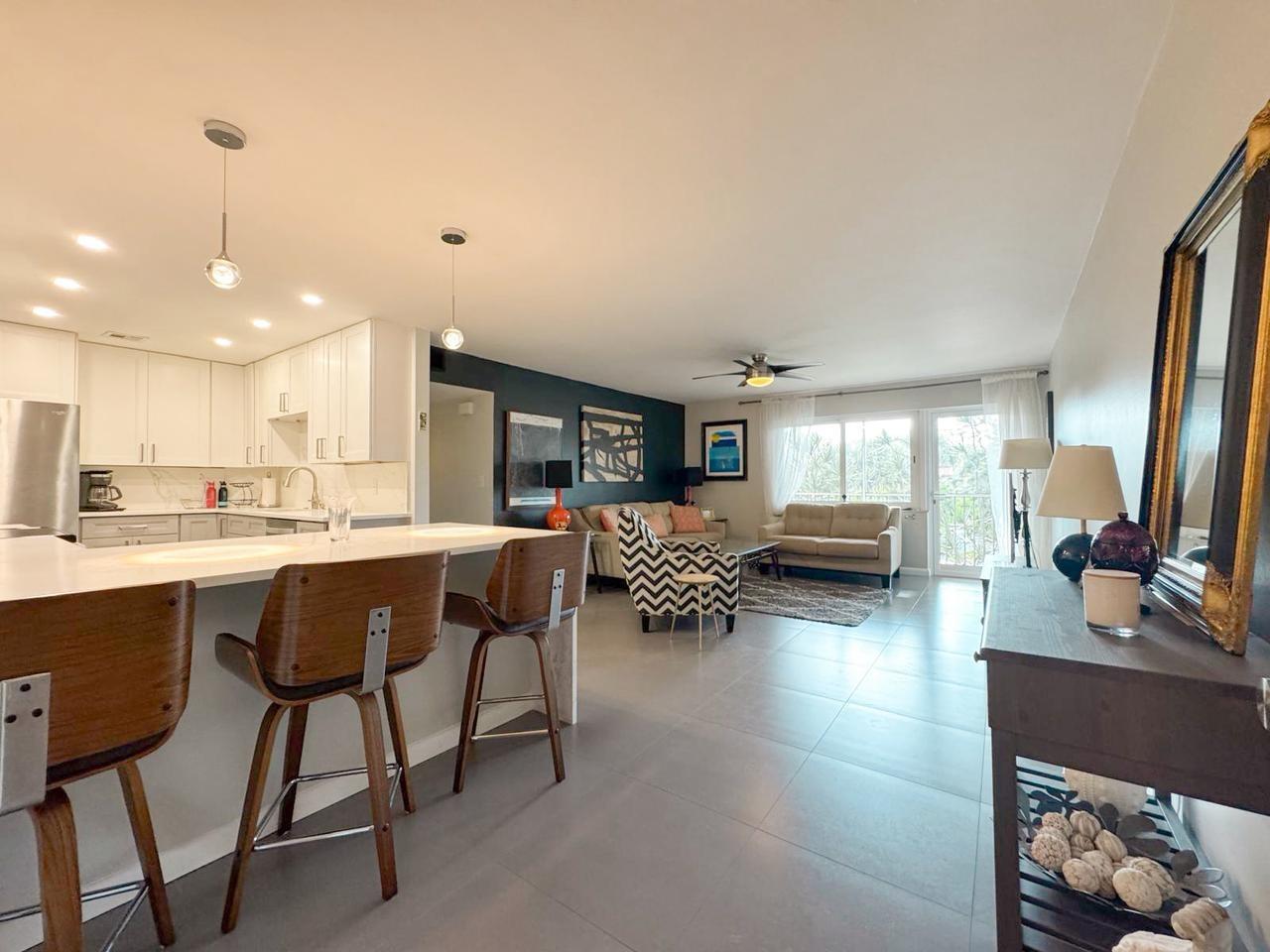 BIG PRICE REDUCED! Move right into this stunning, fully furnished or unfurnished, condo featuring 2 spacious bedrooms and 2 modern bathrooms. The unit has been completely renovated and boasts a sleek new kitchen with quartz countertops, stainless steel appliances, and updated floors, bathrooms, and closets throughout. Enjoy the comfort of a large master bedroom and a generously sized guest room. This condo includes an assigned parking space with plenty of guest parking available. Located just minutes from vibrant Wilton Drive, you’ll love the convenience and lifestyle this location offers. Manor Grove Village 2 is a well-maintained community offering fantastic amenities, including a heated pool, clubhouse, billiards room, BBQ area, and more. Small pets (up to 20 lbs) are welcome!