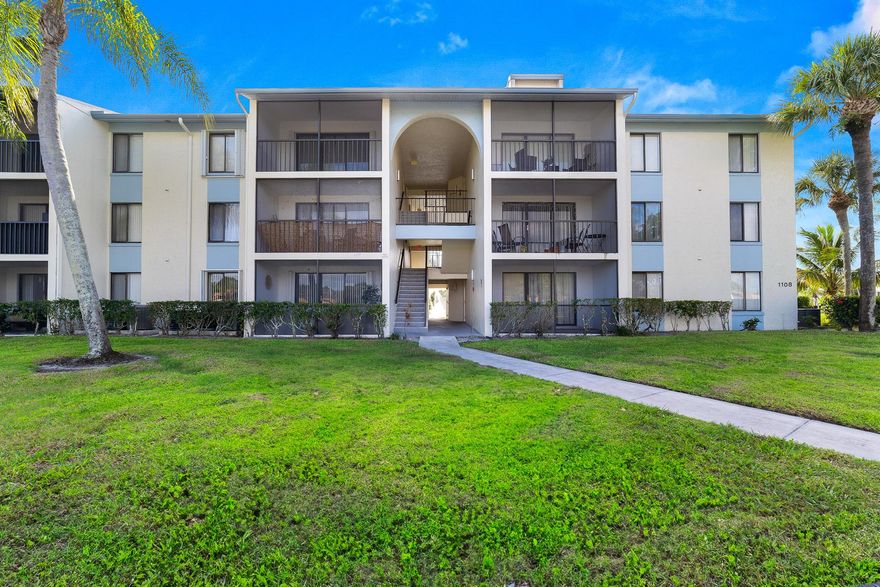 This move-in-ready 2-bedroom, 2-bath condo is located in the gated Palm Club Village II community and offers comfort, convenience, and a peaceful setting. Situated on the third floor, the home features a skylight that fills the space with natural light, along with an exterior storage closet for added functionality. The interior has been partially renovated and includes new waterproof flooring, quartz kitchen counters, stainless steel appliances, and a washer and dryer in the unit. The living area opens to a balcony overlooking the canal, creating a relaxing place to unwind. A mounted 65-inch TV and all furnishings currently in the unit are included. Community amenities include a pool, clubhouse, tennis courts, and a scenic path around the lake with fountains, benches, and grills.