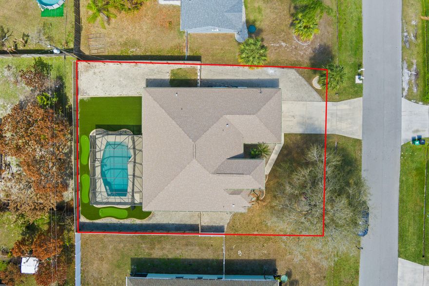 This upgraded 4-bedroom, 2-bath home with a 2-car garage delivers space, style, and a backyard designed for Florida living. Inside, enjoy tile flooring, fresh interior paint, updated lighting and ceiling fans, and a renovated primary bathroom. The flexible layout offers a family room, formal dining area, and separate living room, ideal for everyday living or entertaining. The kitchen features newer appliances including a refrigerator with interior water filtration. Step outside to a saltwater pool and a unique backyard retreat with artificial turf and a three-hole mini golf area. Major updates include a new roof (2025), new fencing (2024), gutters, and exterior paint in 2023.