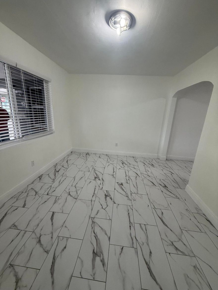 Welcome to your new home in the vibrant community of Lake Worth Beach. This recently renovated apartment is attached to a home and has it's own entrance and  is designed to provide a cozy and stylish living experience. Whether you are a beach lover, shopping enthusiast, or social butterfly this charming apartment is close to it all. The generously sized bedroom is a sanctuary filled with natural light and has a walk-in closet that offers ample storage. An outdoor patio area is perfect for enjoying the weather or entertaining. One dedicated parking spot in the driveway and plenty of street parking as well. Electric and water are included. Don't miss this opportunity to make this delightful apartment yours, schedule your showing today!