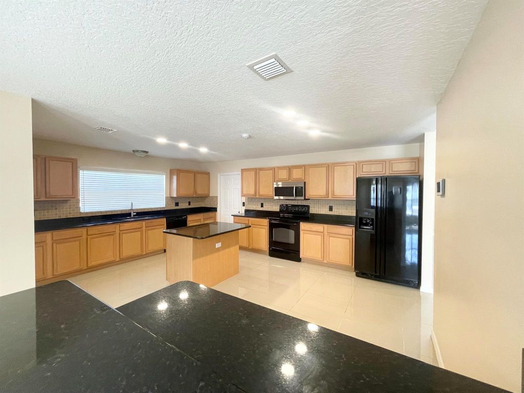 Photo of 5758 NW Cleburn Drive, Port Saint Lucie, FL 34986 (MLS # R11059144)