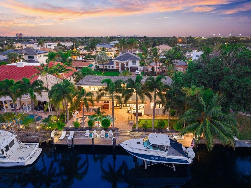 Experience the best of coastal living in this stunning Lighthouse Point waterfront home. Enjoy 80’ on a dredged canal with no fixed bridges, a 20,000-lb lift, and a saltwater pool with new heater and chiller. The chef’s kitchen impresses with a glowing onyx island, Thermador and JennAir appliances, and Miele dishwasher—perfect for entertaining. Outdoors, relax by the grill and bar, unwind in the spa, or practice your swing on the private putting green surrounded by lush landscaping. Featuring impact glass, surround sound, security, newer ACs, and a sealed roof. Just minutes to the beach, shopping, and dining, this home defines effortless South Florida luxury.