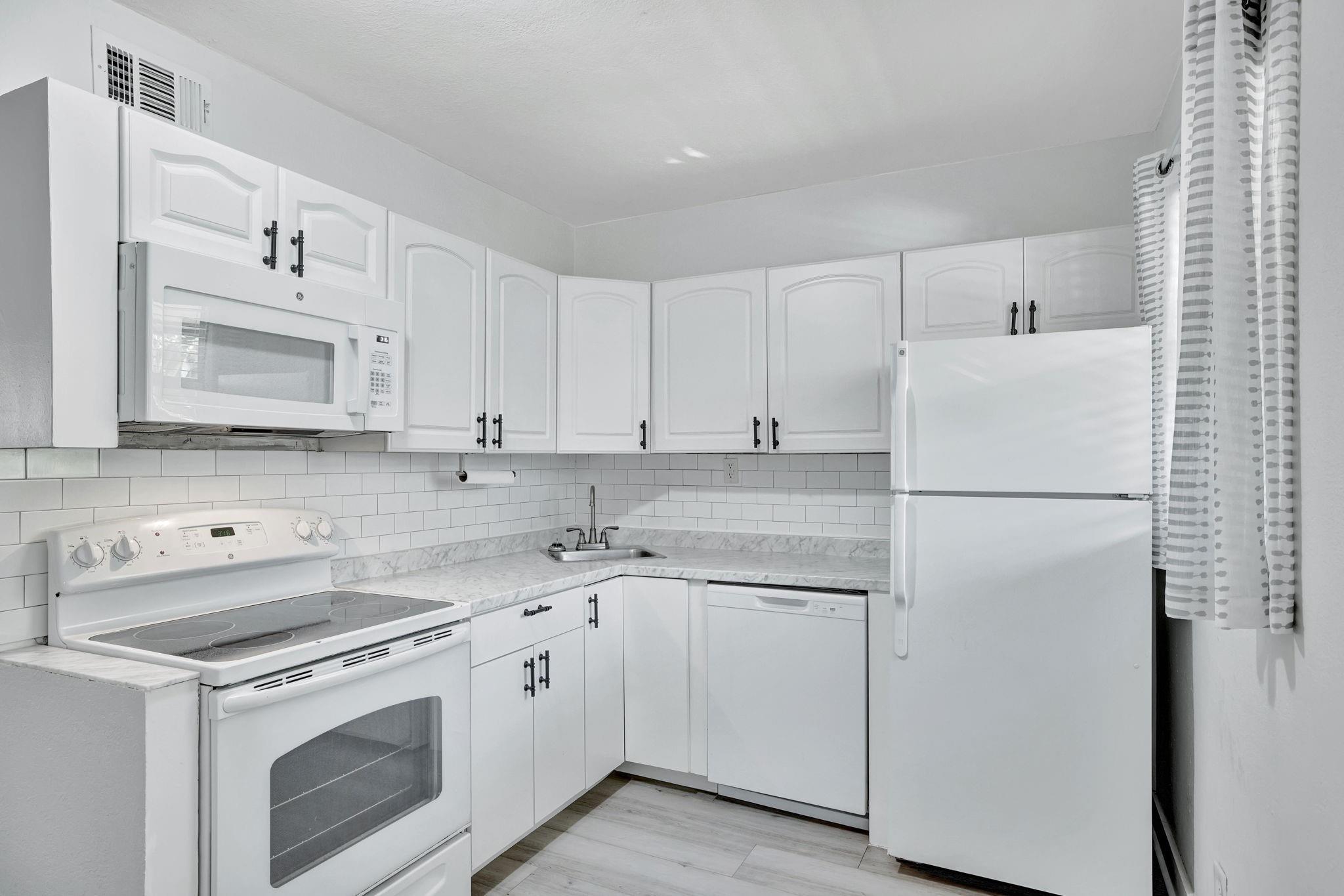 This bright and clean 2 bed 1 bath is walking distance to The Drive in Wilton Manors. The Unit has brand new vinyl flooring throughout (including the bathroom) and all matching white kitchen appliances with a new dishwasher and microwave oven! The entire place has been freshly painted a tasteful grey & white modern color scheme. Recently replaced AC. NEW water heater 2024. Situated on the 2nd (top) floor of the building this unit offers added privacy and has all noise reducing hurricane impact windows, liberal pet policy, NO waiting period to rent. Laundry facilities on the premises (not in the unit). NEW ROOF AND EXTERIOR PAINT IN 2024. Close to all restaurants, shops and entertainment. I assigned parking space. Common area/community yard. This is a GREAT INVESTMENT opportunity as well.