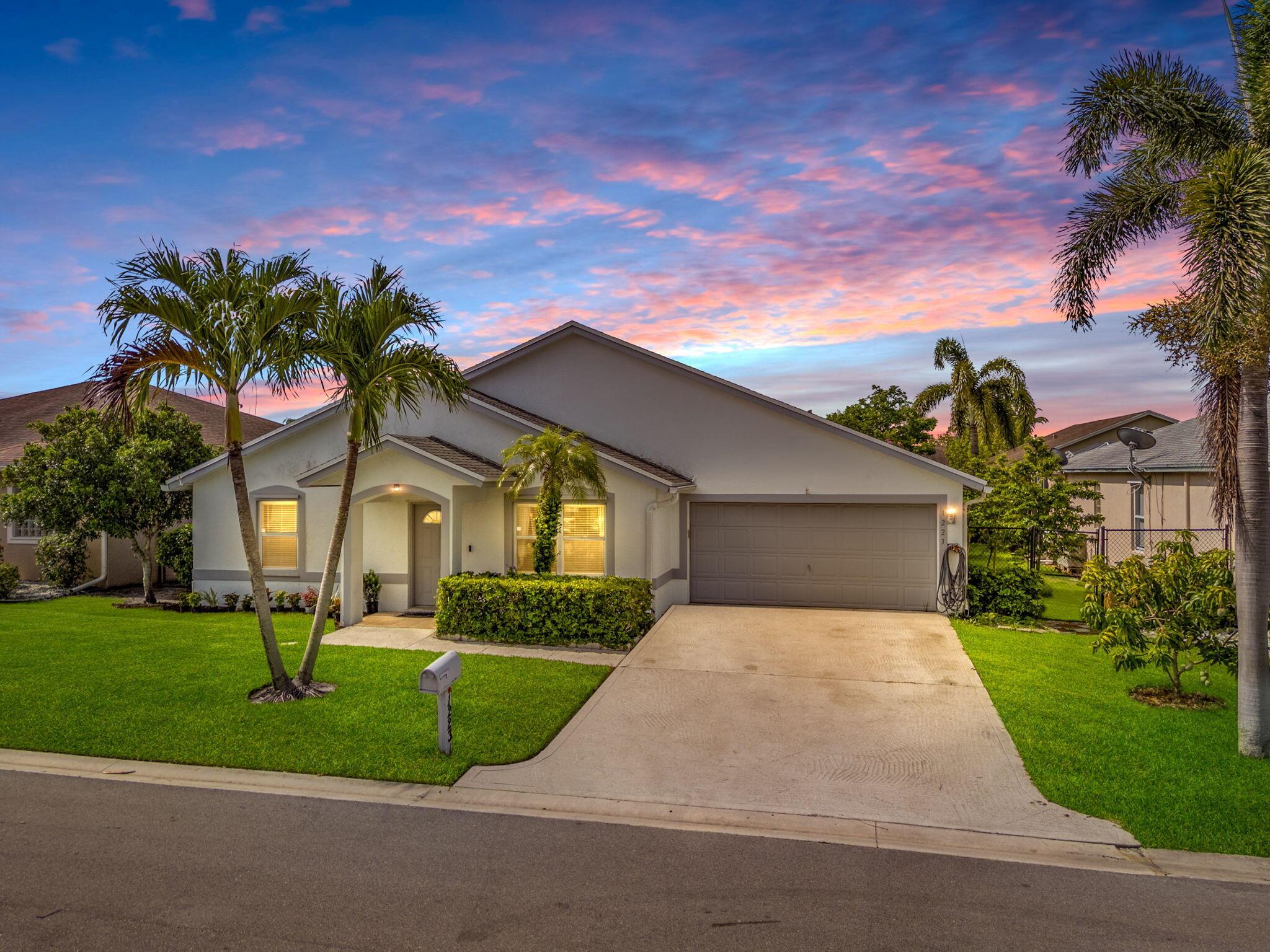 Spacious and meticulously maintained 3-bedroom, 2-bathroom home with a large Florida Room and 2-car garage, located in the desirable gated community of Normandy Isles. Built with solid CBS construction, this home features a double-strapped roof, qualifying for homeowner's insurance discounts, and hurricane panels for storm protection. Recent updates include a new AC (2022), upgraded Wood Flooring throughout the entire house (2020), Gas Hot Water Heater (2020), and Garbage Disposal replaced (2019). Inside, you'll find a spacious upgraded kitchen with wood cabinetry, granite countertops, and a beautiful backsplash. LVP flooring graces all bedrooms, hallways, kitchen, and family room. The primary suite was thoughtfully expanded by the builder to include a linen closet, bathtub, and a larger