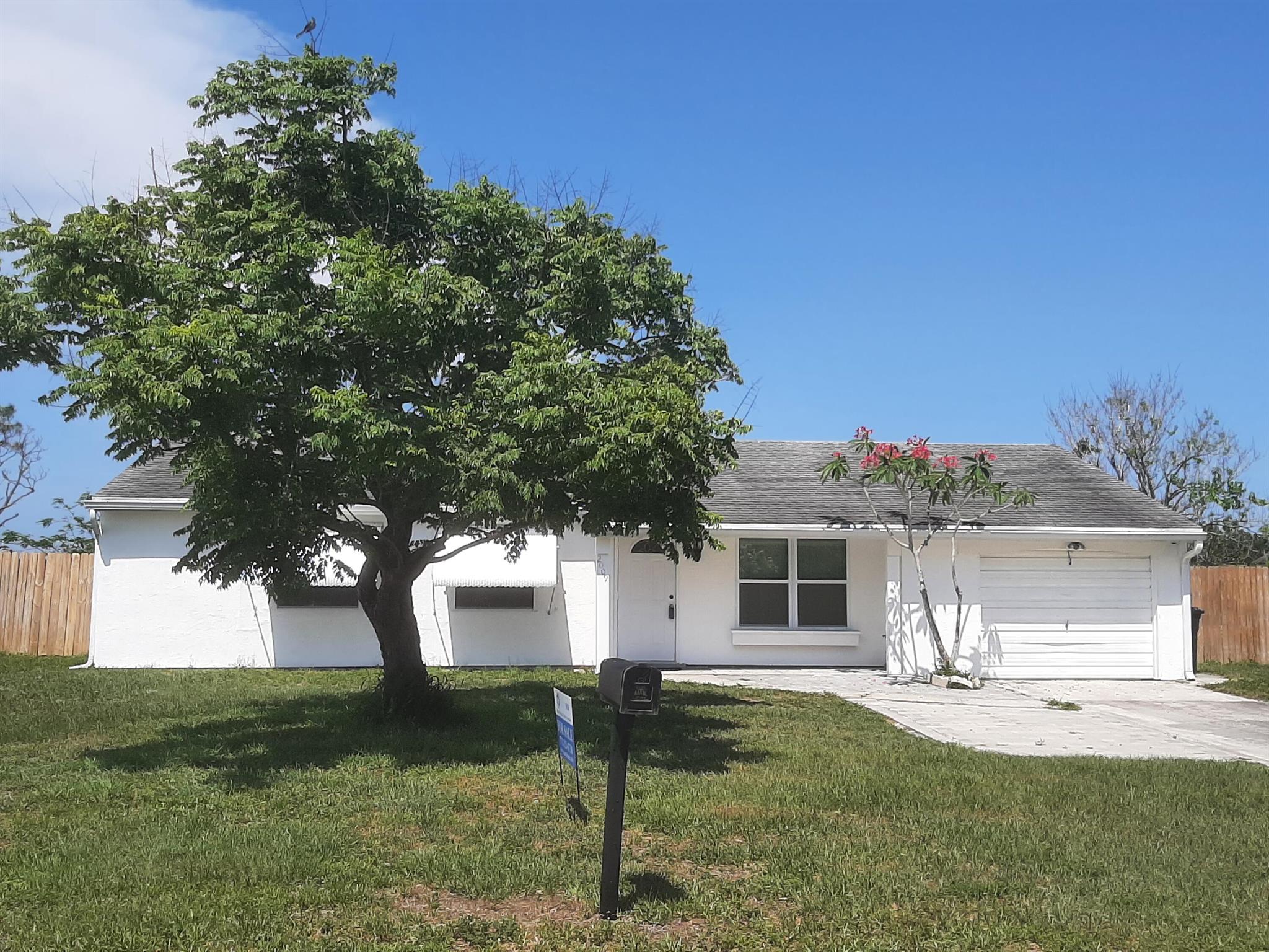Discover the exceptional versatility of this charming single-family home, ideally situated in a central location near the Civic Center, St. Lucie Hospital, and convenient shopping destinations right here in Port St. Lucie. The property features 13 Impact Windows, a large, fully fenced backyard and one of the home's rooms has its own private full bathroom and a separate entrance, presenting a unique opportunity for supplemental income or multi-generational living.This property offers a remarkable range of possibilities for its new owner. Envision living comfortably in two of the bedrooms while generating rental income from the separate suite, or maximize your investment potential by renting the home to two distinct tenants, each enjoying their own level of privacy. NEW 2025 A/C System