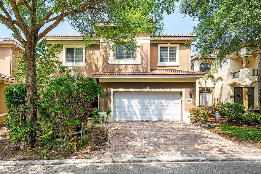 This spacious 5-bedroom, 3.5-bathroom home with a 2-car garage combines comfort, style, and functionality. Featuring elegant crown molding throughout, the home offers a blend of tile, wood, and laminate flooring, chair rail detailing, and smart switches in most rooms.  The oversized kitchen is designed for both everyday living and entertaining, complete with stainless steel appliances, a brand-new 2025 refrigerator, granite countertops, light wood cabinetry with molding, glass cooktop, double oven, wine cooler, pantry closet, and a bright breakfast area.A wrought iron staircase leads to a cozy loft and well-appointed bedrooms. The primary suite features a tray ceiling, spacious his-and-hers walk-in closets, and a split bathroom layout with dual vanities, a Jacuzzi tub, and a walk-in shower One guest bedroom also includes a walk-in closet. A full-size laundry room adds convenience.  Enjoy outdoor living on the covered, paved patio with no rear neighbors, offering added privacy. The home also features a brand-new 2025 roof with a transferable warranty for peace of mind. Located in the gated community of Thousand Oaks, residents enjoy amenities including a heated pool, clubhouse, fitness center, tennis and basketball courts, playground, and 24-hour manned gate. Conveniently close to shopping, dining, medical centers, I-95, local beaches, and just a short drive to downtown West Palm Beach, Rosemary Square, and Palm Beach Gardens.