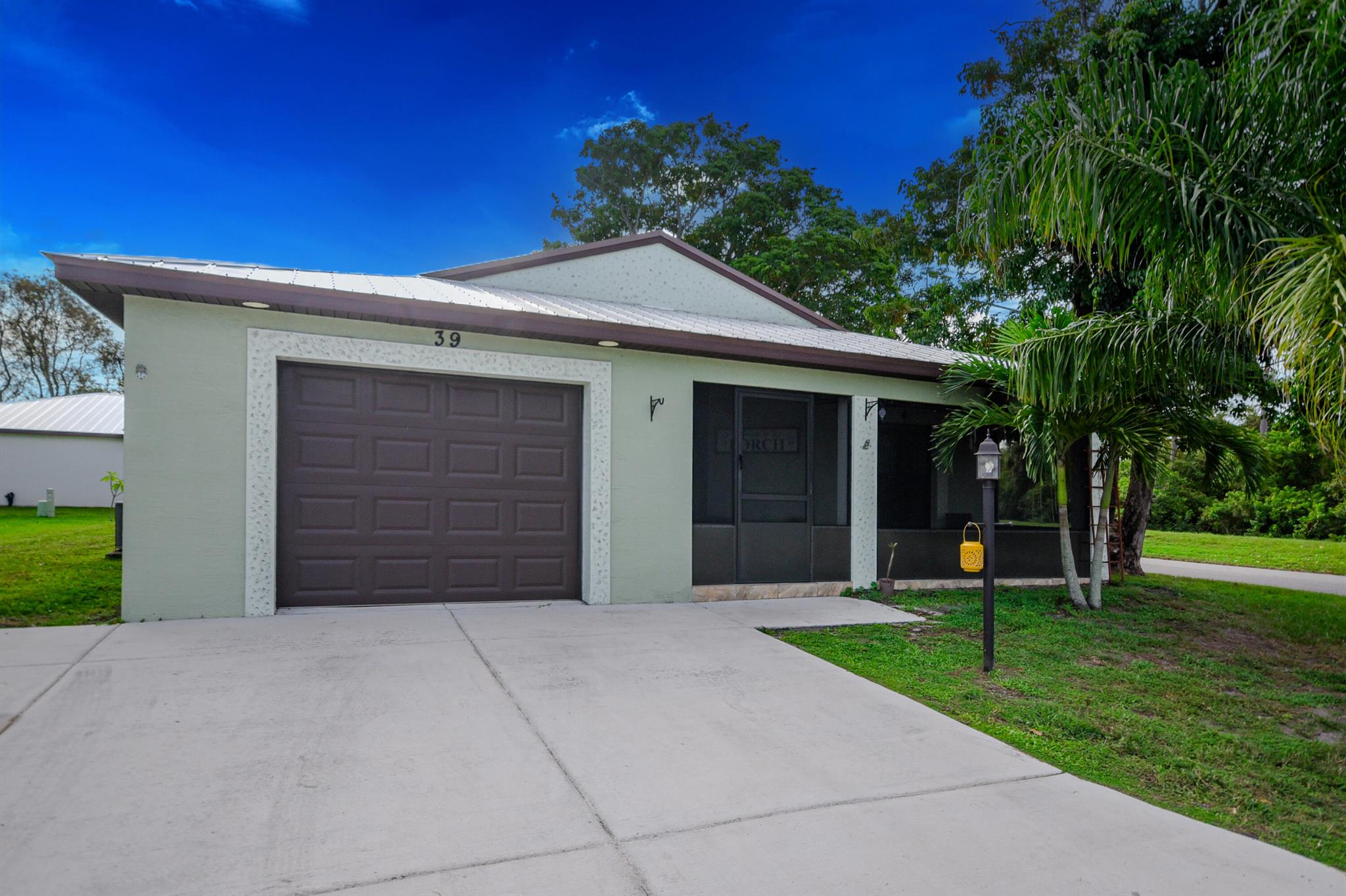 Charming 2-bedroom, 2-bath CBS home built in 2020, located in the highly sought-after 55+ community of Spanish Lakes. Offering 1,357 sq. ft. of comfortable living, this home features hurricane impact windows, a metal roof with a 25-year warranty, stainless steel appliances, stone counters, and a split floor plan with ceramic tile floors. The primary suite includes a large walk-in closet, dual sinks, and a walk-in shower. Enjoy resort-style living with a private 9-hole golf course, two pools, tennis, pickleball, bocce, shuffleboard, billiards, ping pong, a fitness center, library, wood workshop, clubs, activities, golf cart parades, and more! Monthly land lease includes lawn care, trash, sewer, and full use of all amenities. Perfectly located just minutes