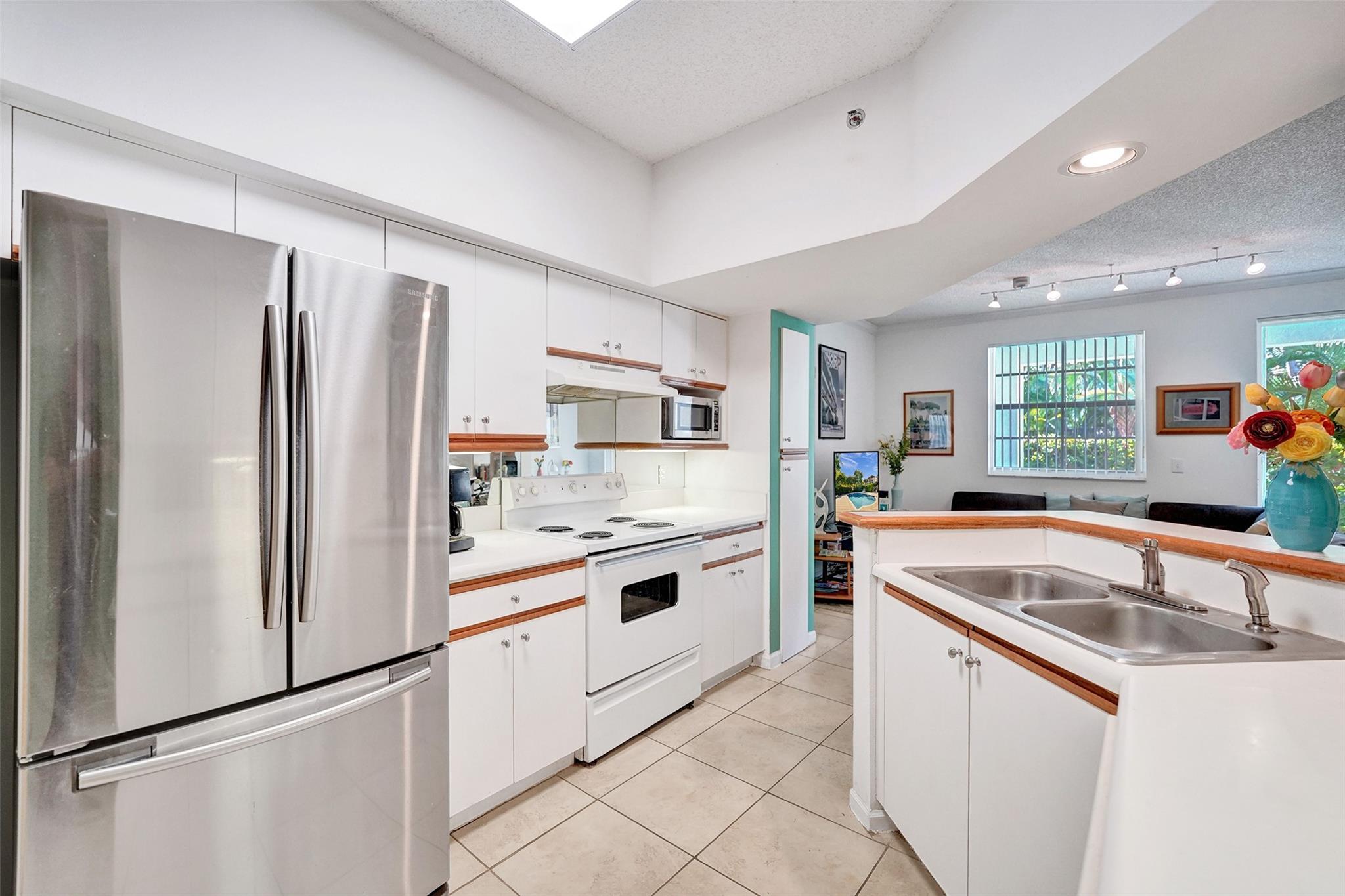 Welcome to your waterfront oasis located on the bay! This first-floor unit offers the perfect blend of comfort and convenience. Enjoy tile flooring, new A/C, tasteful upgrades throughout and a thoughtfully designed closet system in the primary bedroom for all your storage needs. Step outside to your private patio area, ideal for morning coffee or evening relaxation. The kitchen boasts a new refrigerator, and an in-unit washer and dryer to add to the ease of everyday living. Community amenities feature three sparkling pools, a clubhouse, a gym, a sauna, tennis courts and beautiful views of the bay for you to enjoy—perfect for both leisure and fitness enthusiasts. Renting is allowed in this community.
