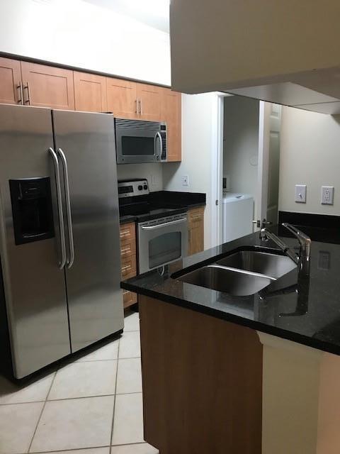 1 bedroom 1 bathroom. One-of-a-kind community, that includes water/sewer, trash & basic cable exceptional quality and so much more. Just a few of this unit features granite counter tops , stainless steel appliances, tile flooring, luxury vinyl plank in the bedroom, European style cabinetry, full size washer and dryer in separate utility room. The community features include two resort style pools with hot tub/spas, lush and beautiful landscaping, magnificent clubhouses with two state of the art fitness centers, media room with HD television, billiard room, business center and conference room. This community features controlled access gates. Minutes from the beach, downtown & PBI.