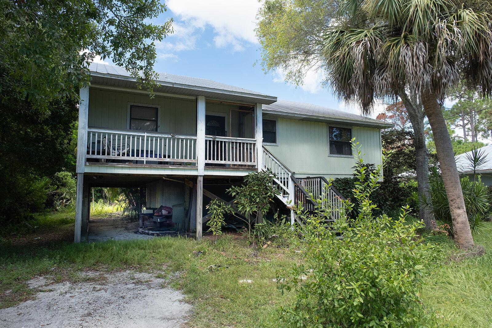This is one of those great homes in Indian River Estates. 2/2 with newer metal roof and volume ceilings the home has a carport underneath the home plus a bonus room downstairs that is awesome for a man cave, workshop, family room, game room sized 21x15! Concrete porch under house and storage all underneath house. Upstairs there is a deck in the back the whole length of the home with triple sliders. Big yard and plenty of parking. needs a little upgrading but it is a great property close to the beach.