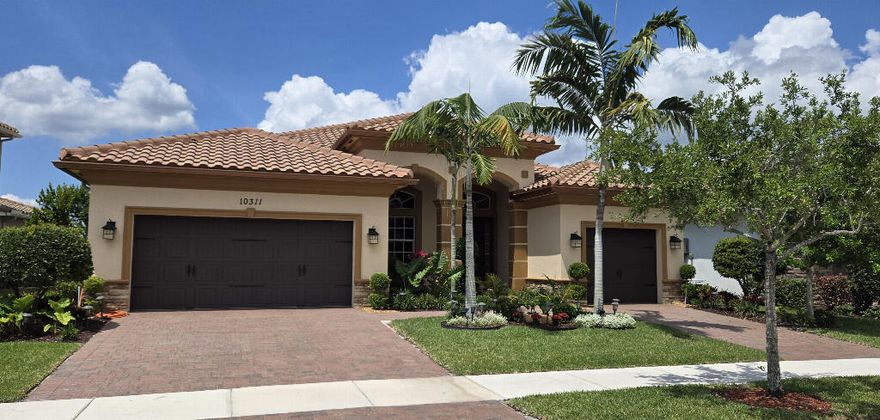 Buyers agents welcome. Enjoy stunning lakefront views from this move-in ready premium 3-way split home. Featuring 4 bedrooms and 3 full bathrooms, this residence combines comfort, elegance, and functionality. The home is equipped with full impact windows and doors, crown molding, custom window treatments, and high-end ceiling fans throughout. The gourmet kitchen is designed for both everyday living and entertaining, offering granite countertops, GE stainless steel appliances, a double oven, and a gas stove. The spacious primary suite includes customized walk-in closets, while the oversized primary bath features dual sinks, a tiled shower, and a relaxing jacuzzi tub.  Additional highlights include: Formal dining room, Full-size laundry room with gas dryer, Tankless gas water heater, and Wired alarm system. Step outside to a large paver patio with room for a pool, perfect for enjoying the lakefront setting. The home has been freshly painted inside and out, with all pavers newly sealed. The HOA covers lawn maintenance and irrigation, providing ease and convenience. Located in an exclusive 24-hour guard-gated community, residents enjoy resort-style amenities including: Two clubhouses Fitness centers Pools and spas Tennis and basketball courts And more Conveniently close to shopping, dining, major highways, and A-rated schools: Elementary: Park Trails Middle: Westglades High: Marjory Stoneman Douglas