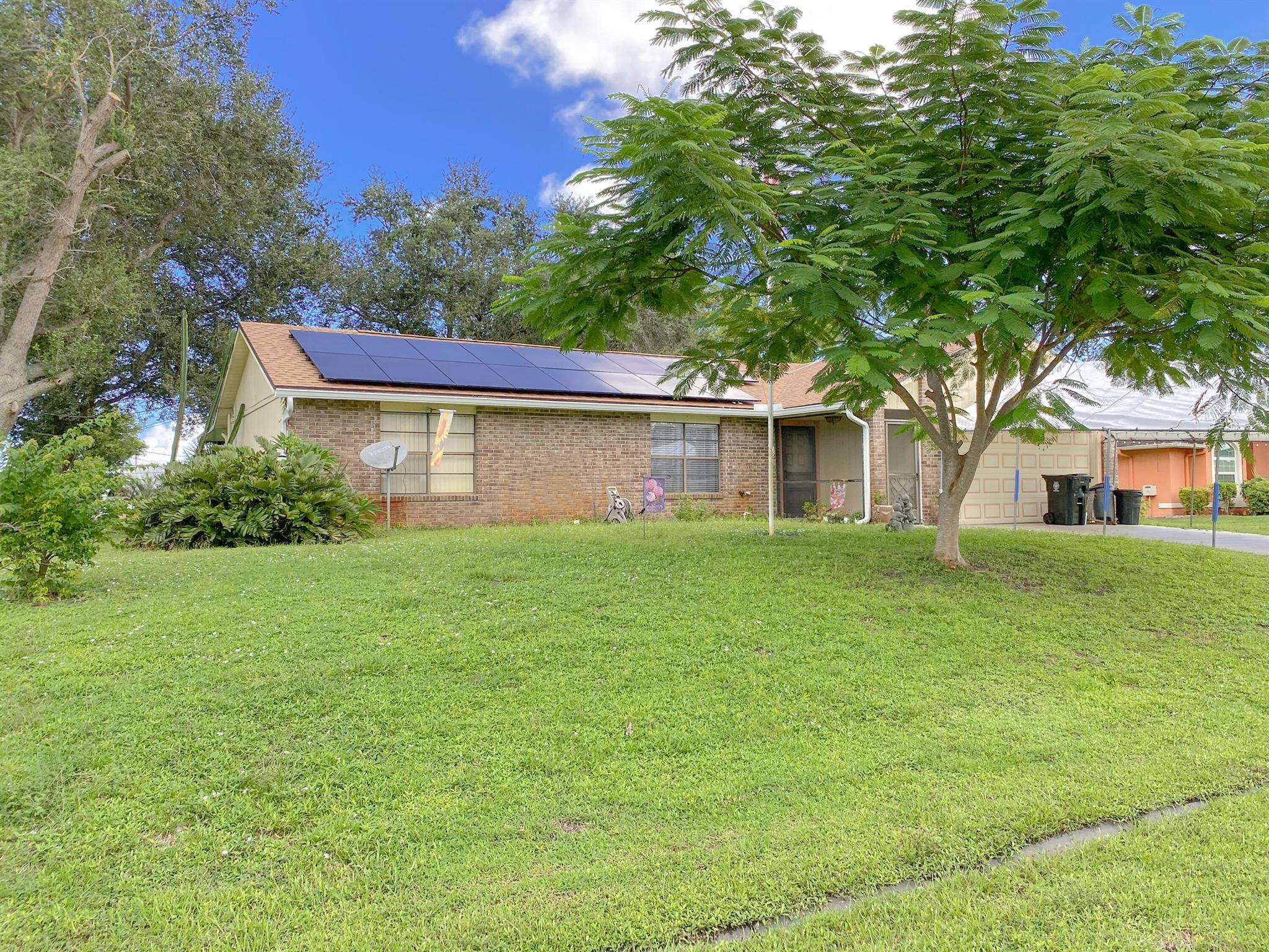 BACK ON MARKET DUE TO BUYER FINANCING FELL THROUGH.Welcome to this charming 3-bedroom, 2-bathroom home with a 2-car garage equipped with an EV 220V charger. Large enclosed 27x12 patio with mini split AC. New Roof 2022, Solar Panels 2022 paid in full, AC 2020, Irrigation system on well water. Enjoy peace of mind knowing that the roof is brand new, providing years of protection and energy efficiency. Say goodbye to high electricity bills; this home comes with fully paid-in-full solar panels, a valuable eco-friendly addition. The spacious primary bedroom features a private bathroom and his-and-her closets, offering a serene retreat within your own home. The kitchen is both functional and inviting, complete with an eat-in area and stainless steel appliances.